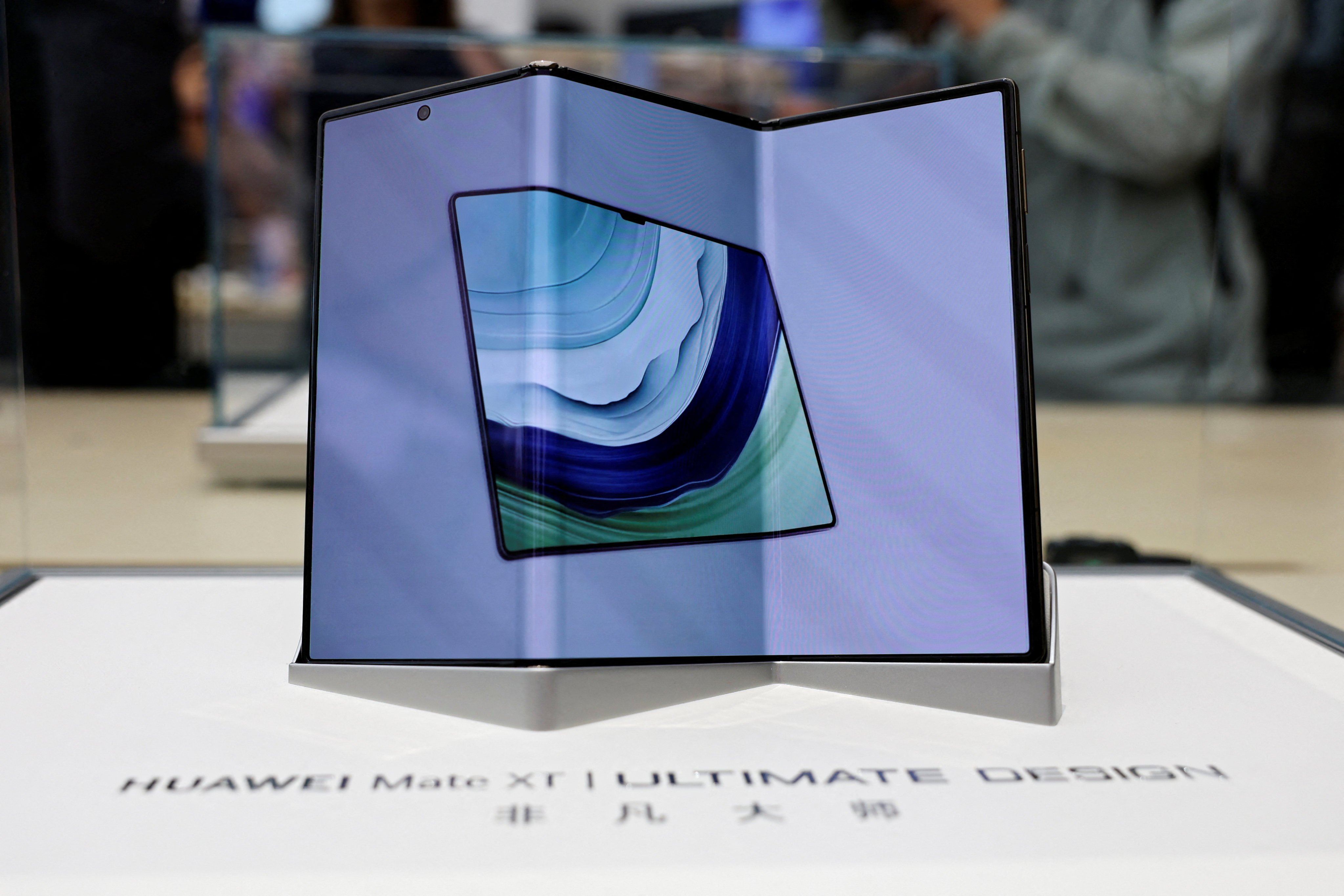 Huawei Technologies’ new tri-fold smartphone, the Mate XT, is displayed in a glass case at the company’s flagship store in Beijing on Tuesday. Photo: Reuters