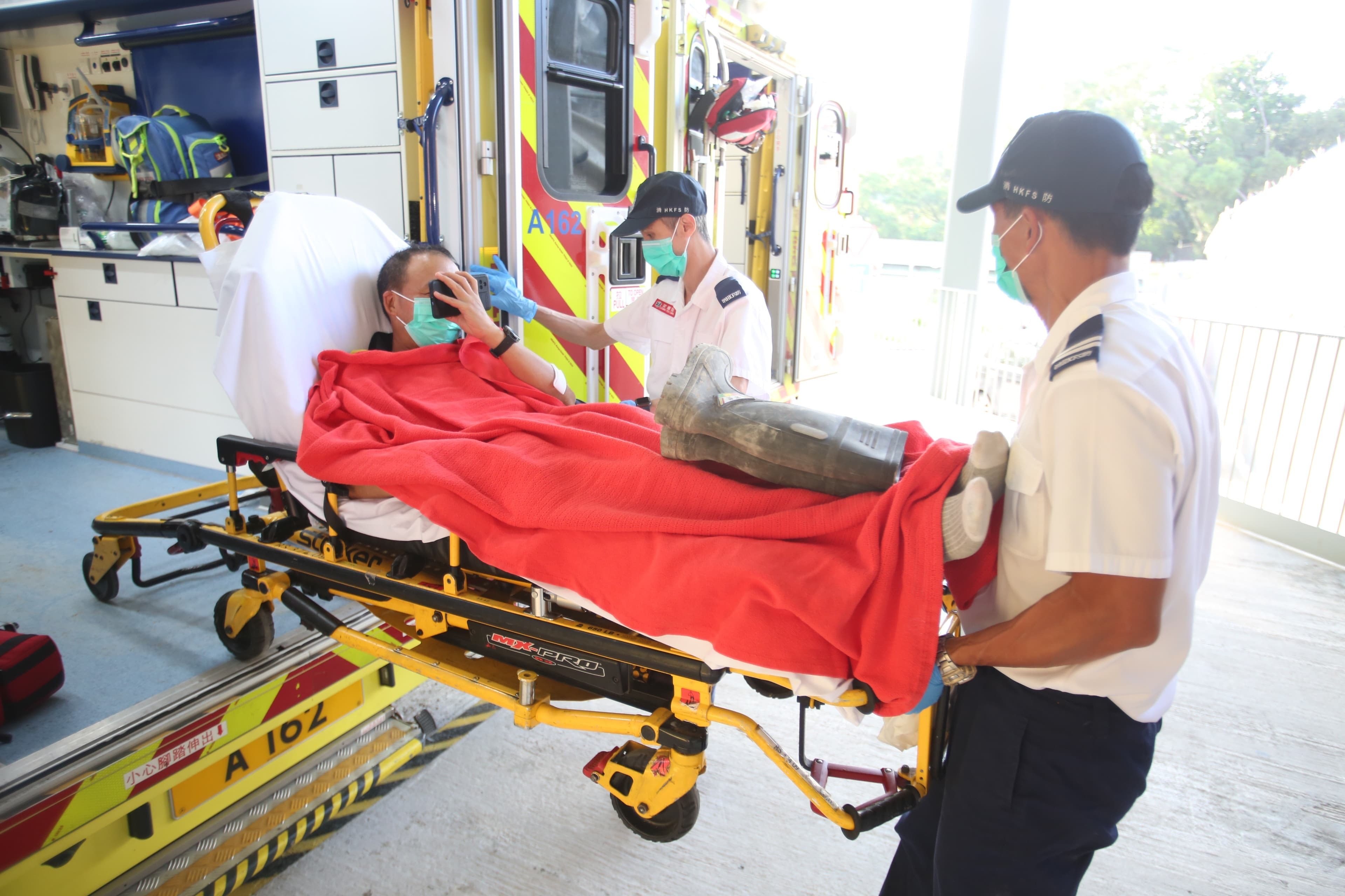 One of the injured workers is transported to hospital after the accident. Photo: SCMP