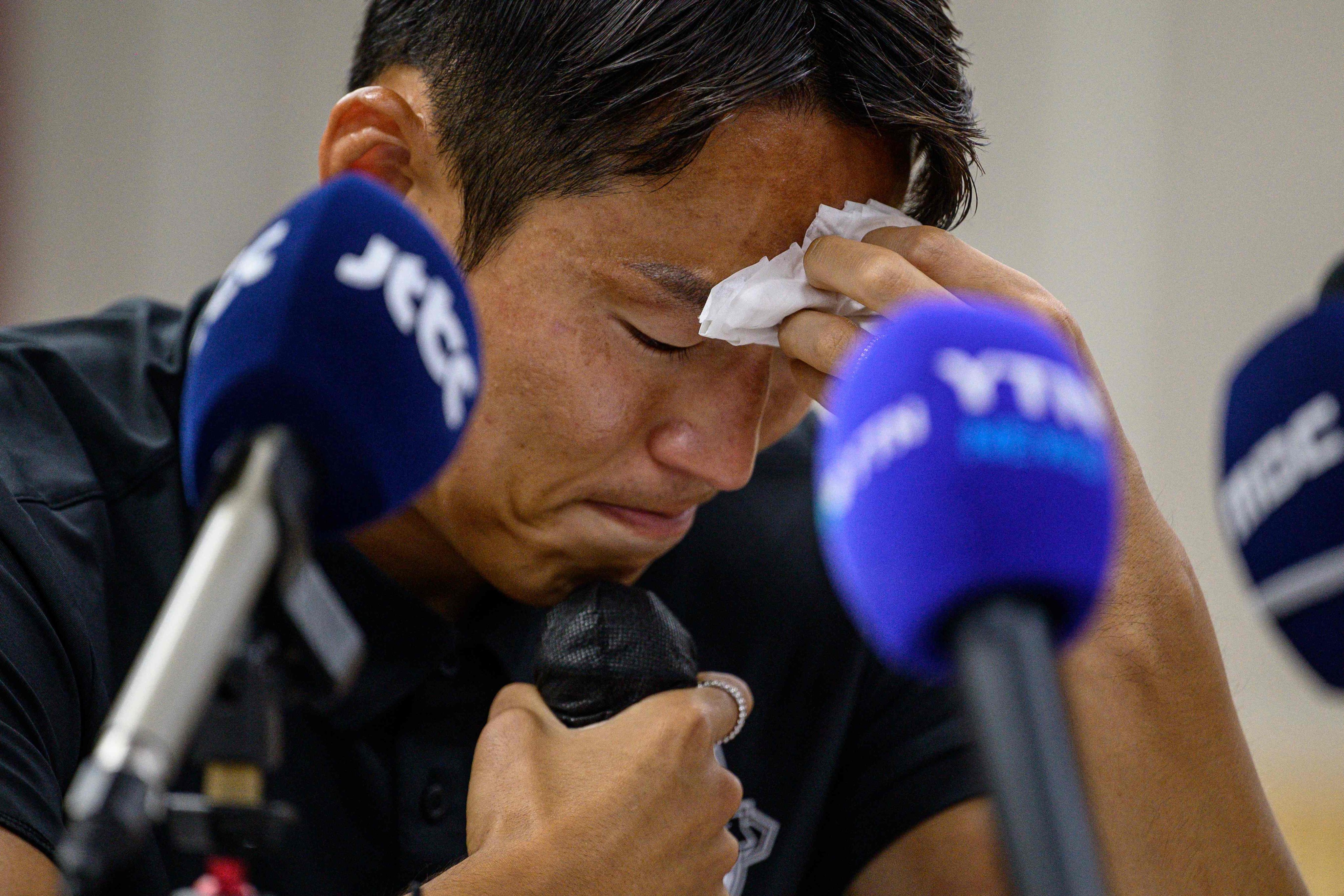 South Korean footballer Son Jun-ho holds a tissue as he speaks during a press conference at his K League club Suwon FC. Photo: AFP