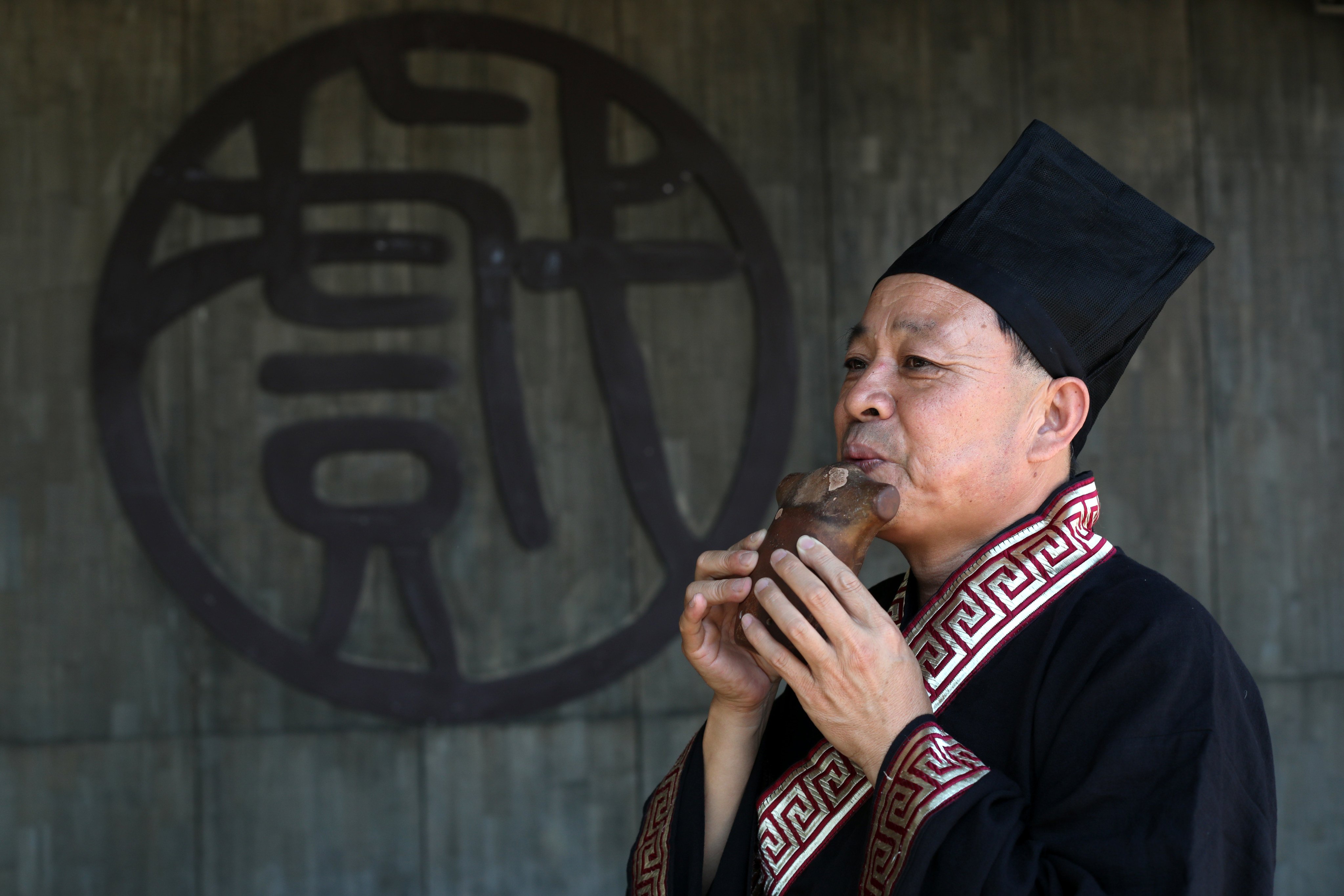 A musician plays the xun, an ancient Chinese clay flute that began life as a hunting tool to attract prey. Today, it is the signature clay instrument of modern Chinese orchestras. Photo: Xiaomei Chen