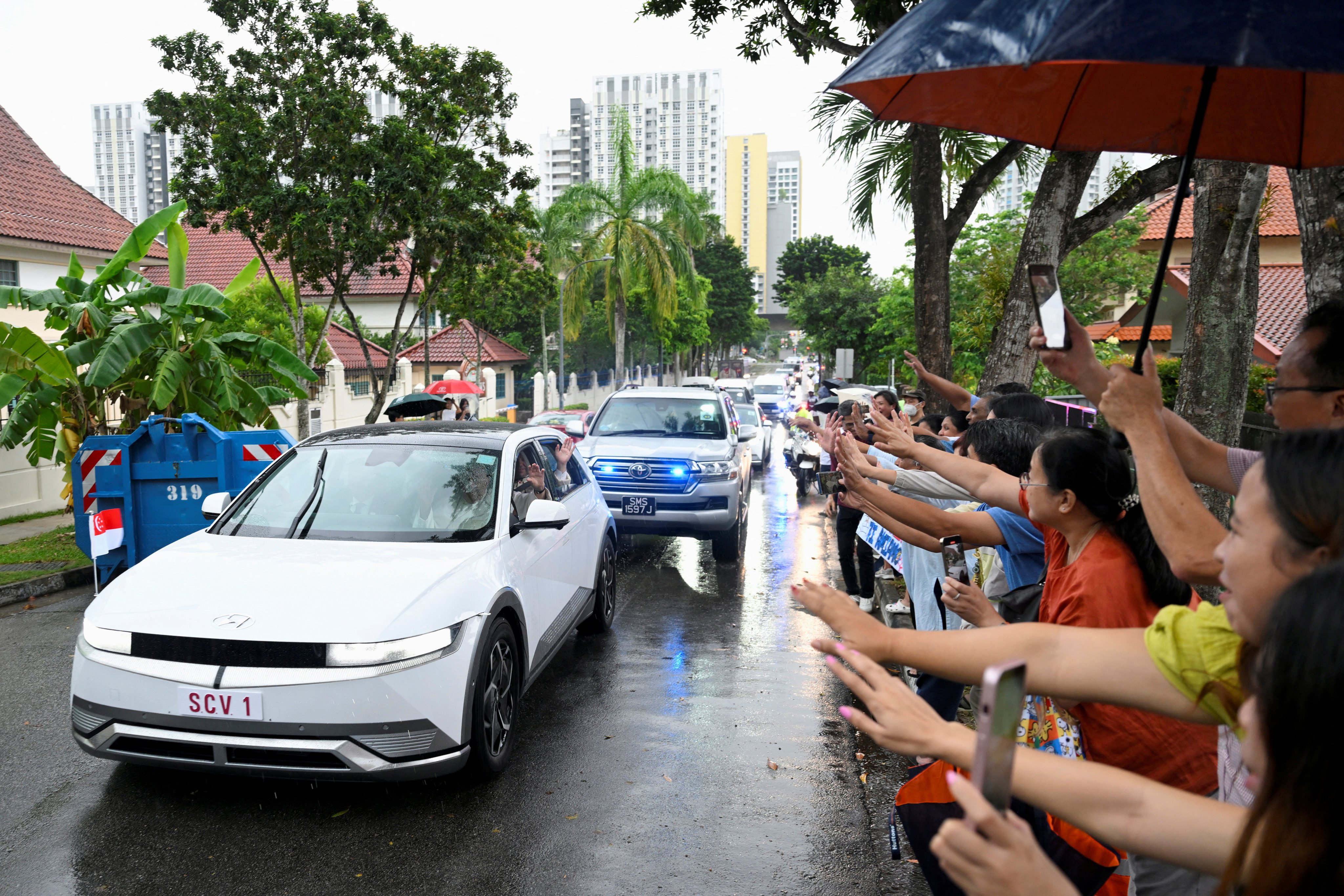 People line the road to catch a glimpse of Pope Francis in Singapore. Photo: Reuters