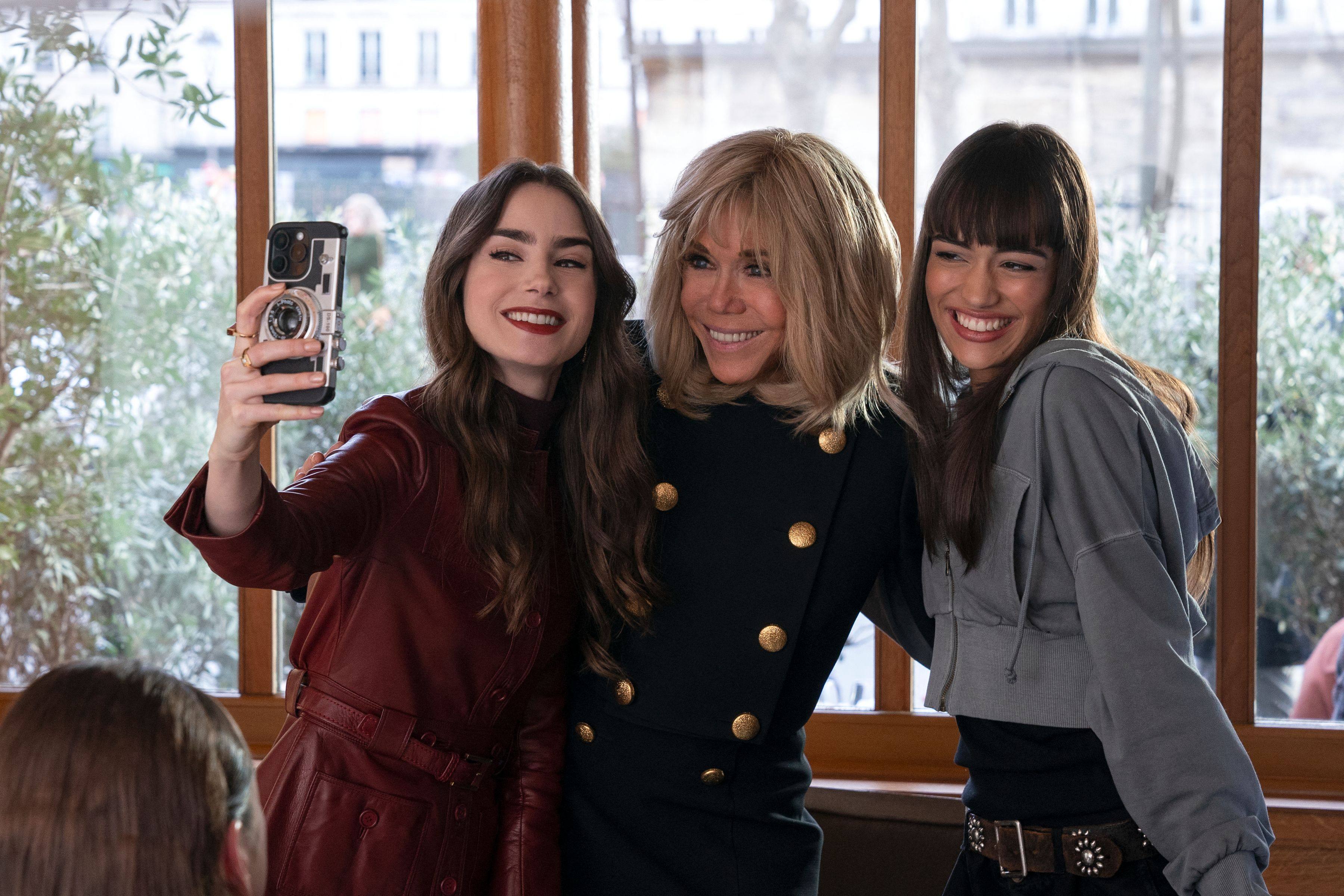 Brigitte Macron (centre) poses for a selfie with Emily in Paris stars Lily Collins (left) and Thalia Besson. The French first lady, who the Netflix show’s creator said has “great talent”, will make an appearance in an upcoming episode of season 4. Photo: AFP