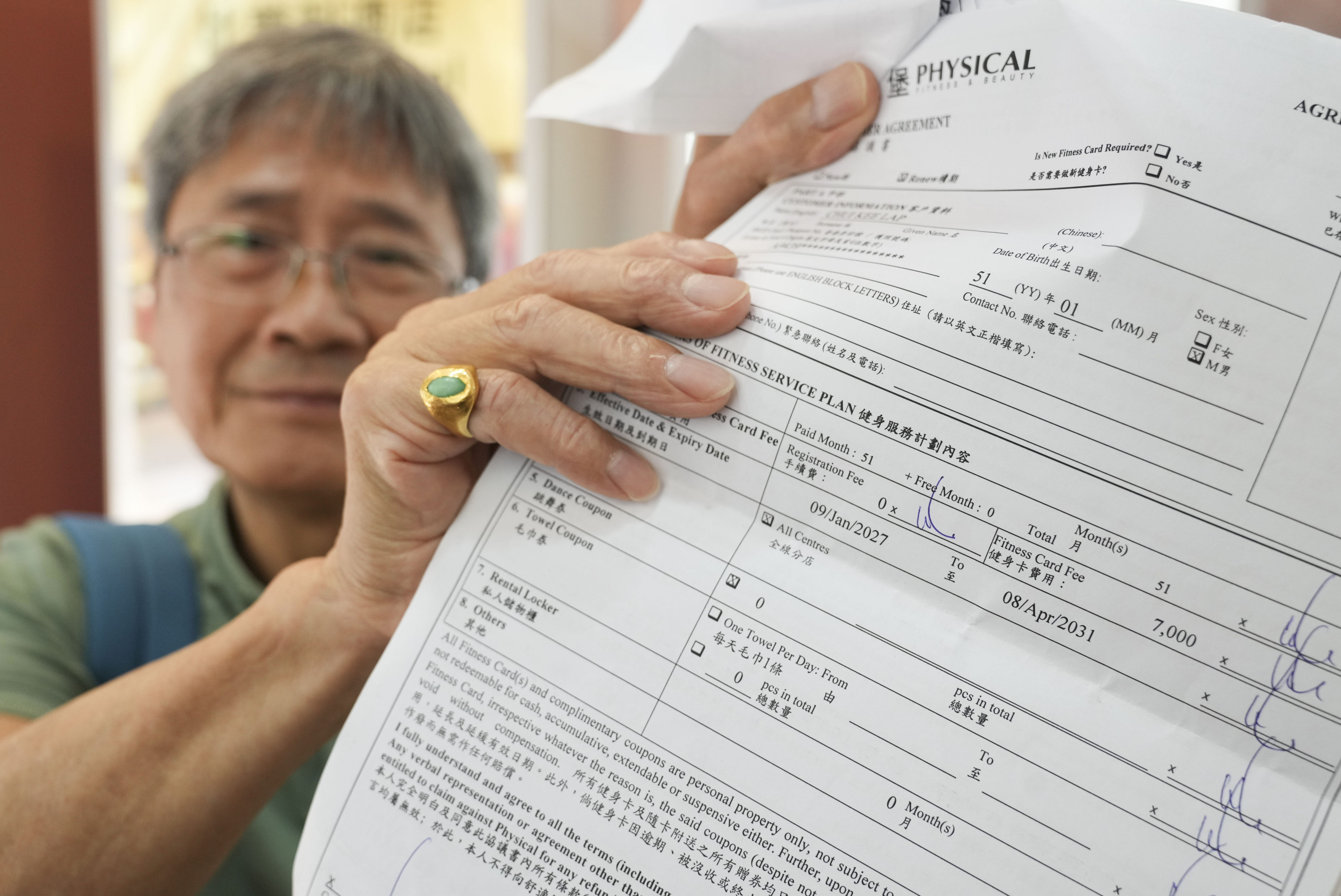 A former customer shows a contract with the gym chain. The total amount involved in complaints made to customs doubled in a day, surging to HK$71 million. Photo: Sam Tsang