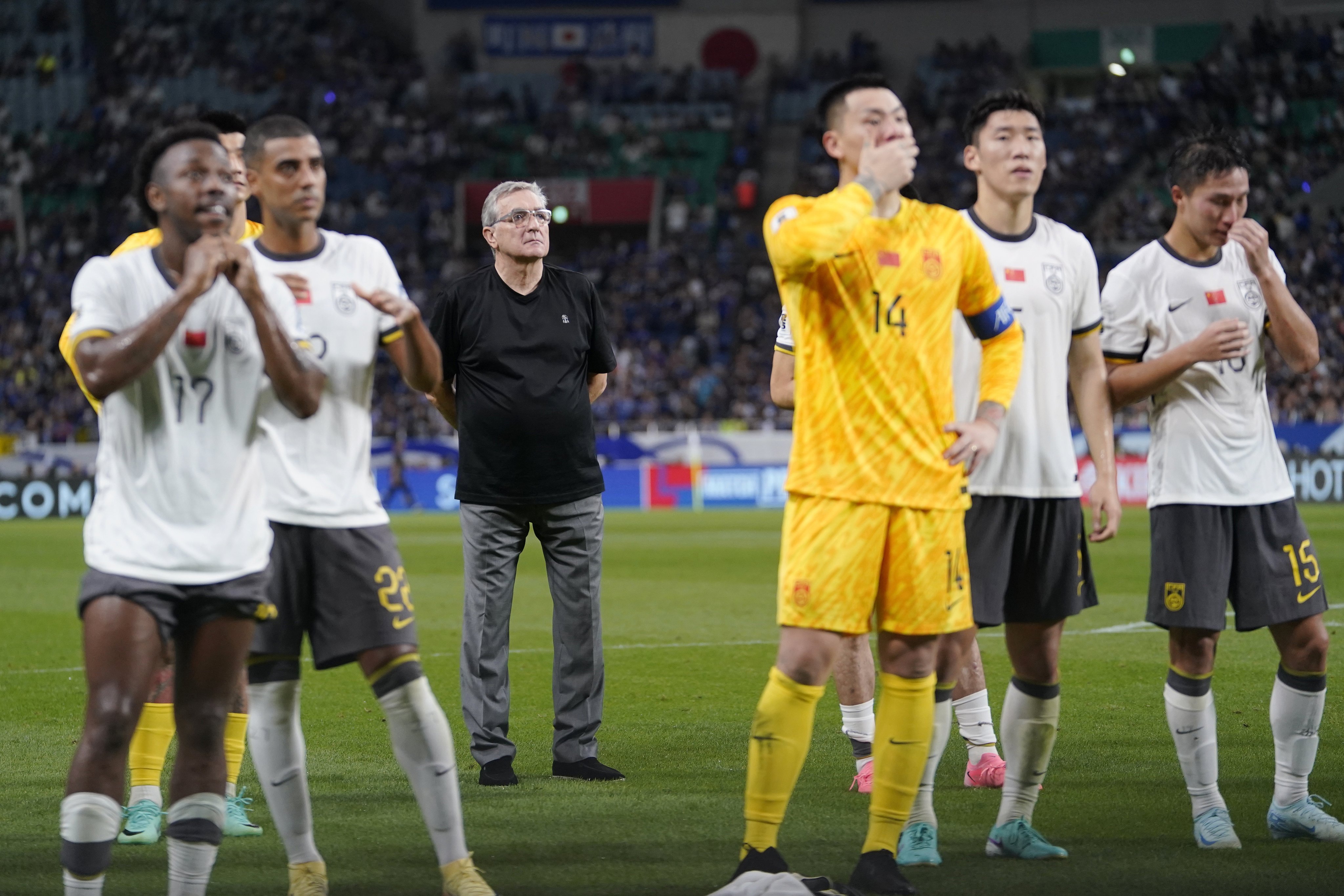 Head coach Branko Ivankovic (centre, rear) and China players react during the team’s 7-0 drubbing by arch-rival Japan in the World Cup qualifying match. Photo: EPA-EFE