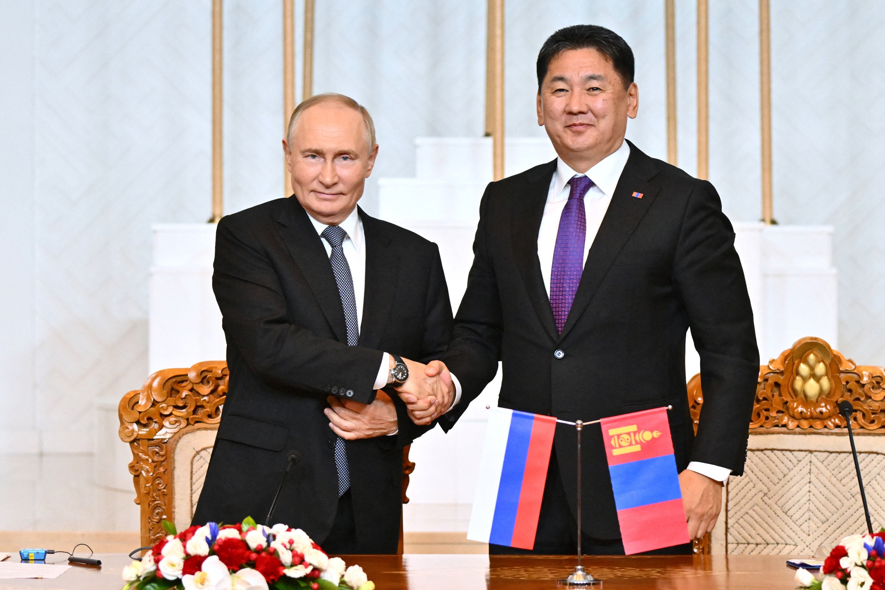 Russia’s President Vladimir Putin and Mongolia’s President Ukhnaagiin Khurelsukh shake hands during a joint media statement following their talks in Ulaanbaatar, Mongolia, on September 3. Photo: TNS