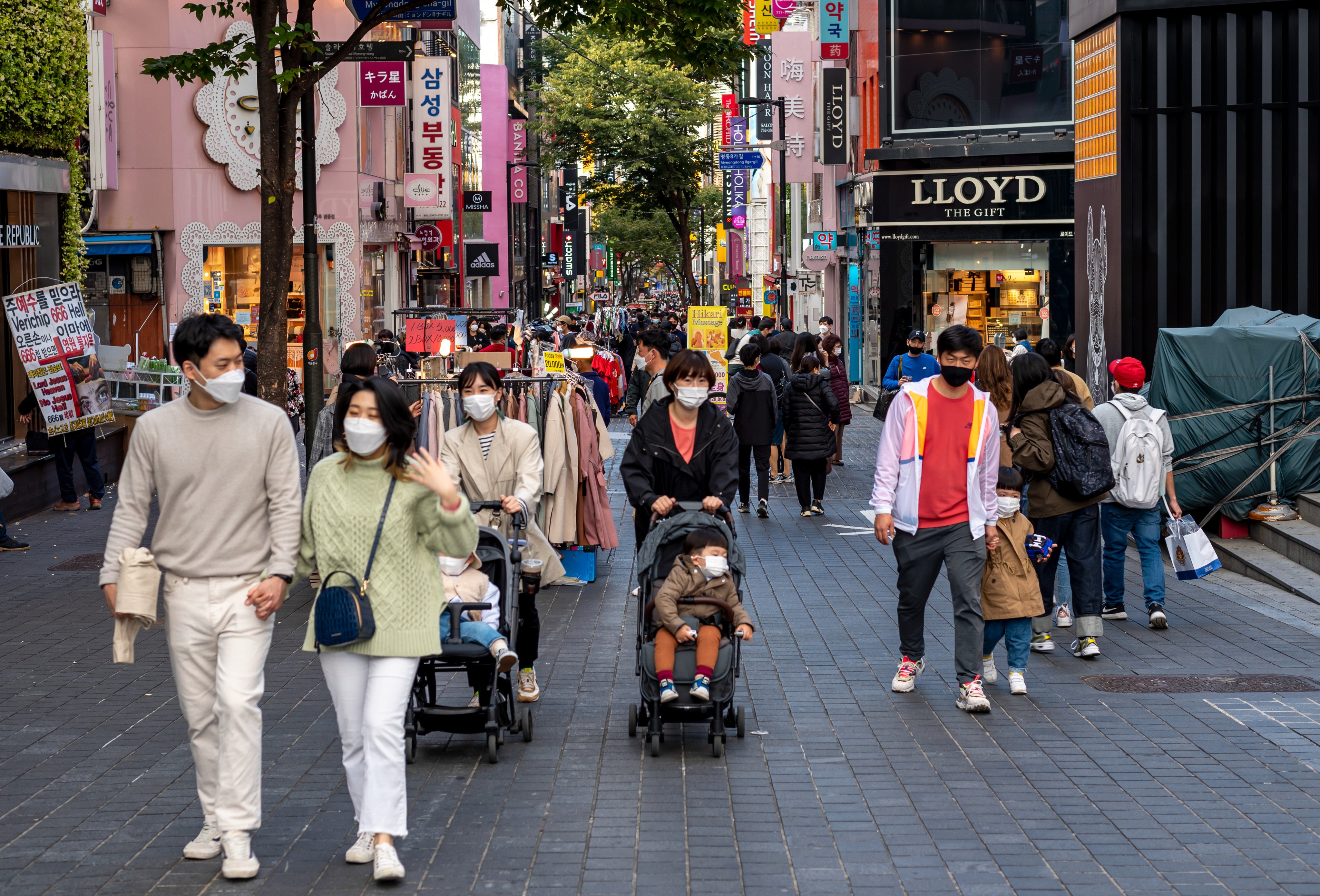 Parents with their children walking in the Myeong-dong shopping street in Seoul. Photo: Shutterstock