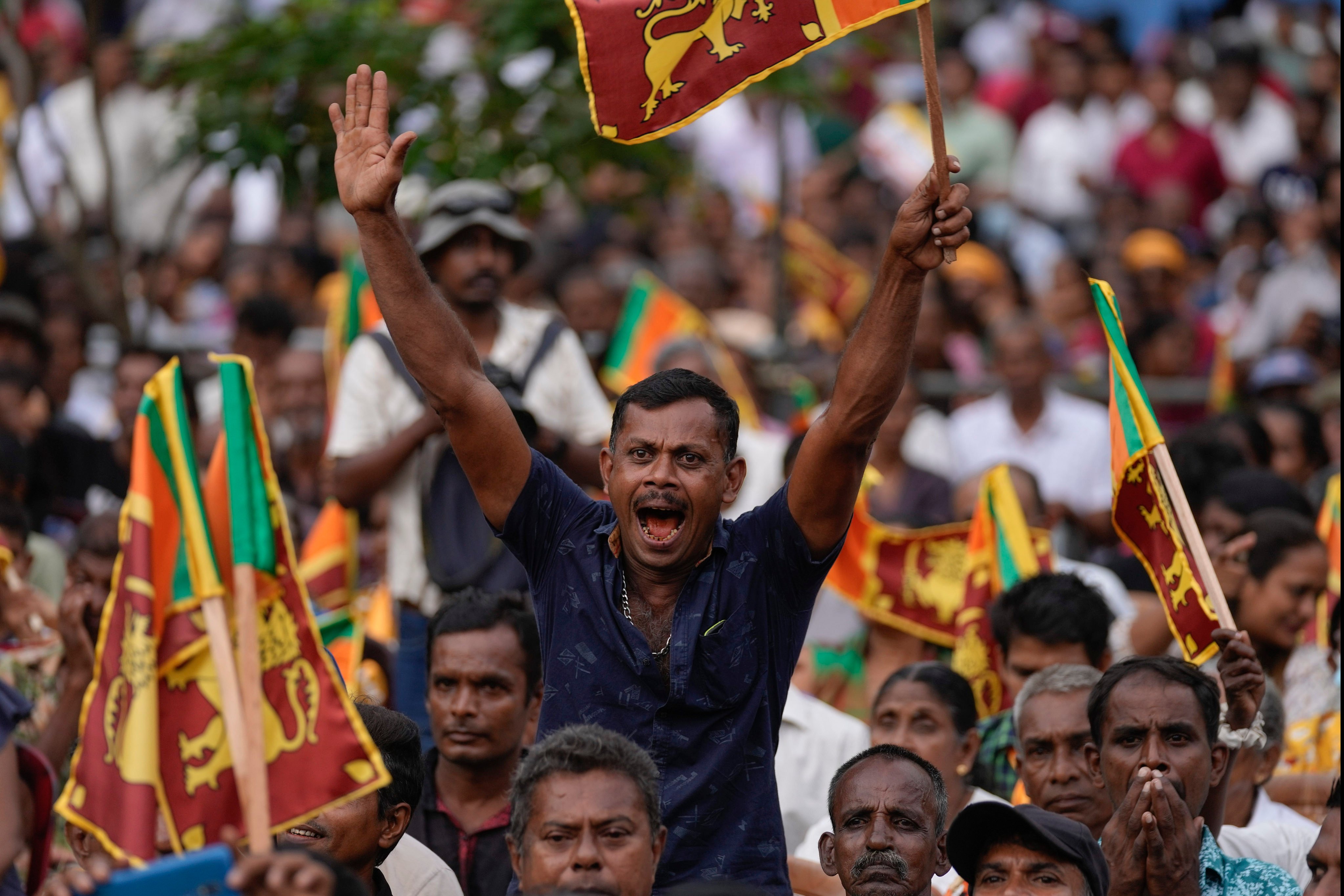 Voters wave Sri Lankan flags during a public rally in Colombo. Photo: AP