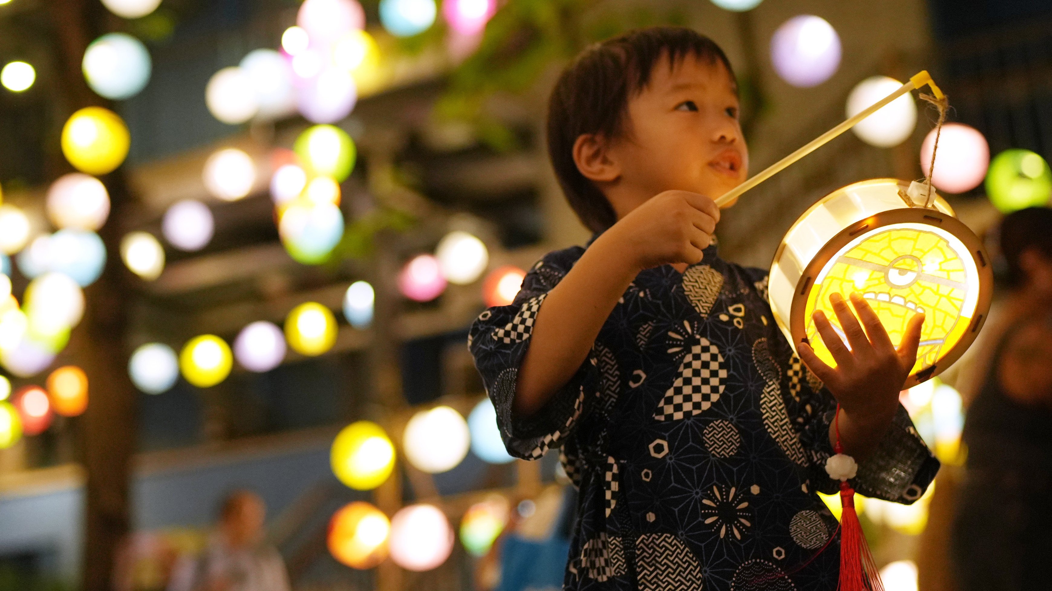 A boy with a lantern outside the Blue House in Wan Chai on September 9, 2024. Photo: Sam Tsang