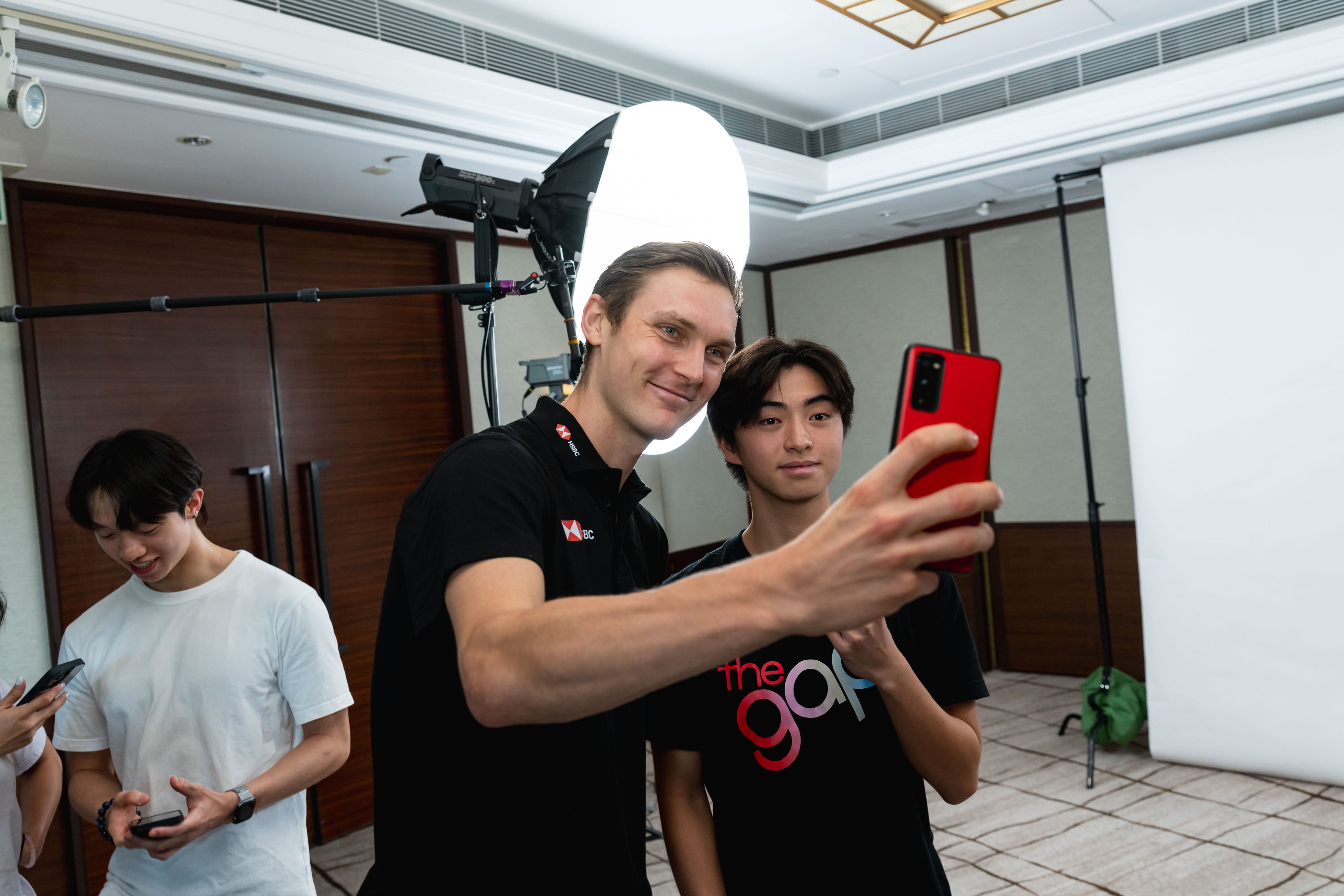 Viktor Axelsen satisfies selfie requests after sharing with the students what life under the spotlight is like. 