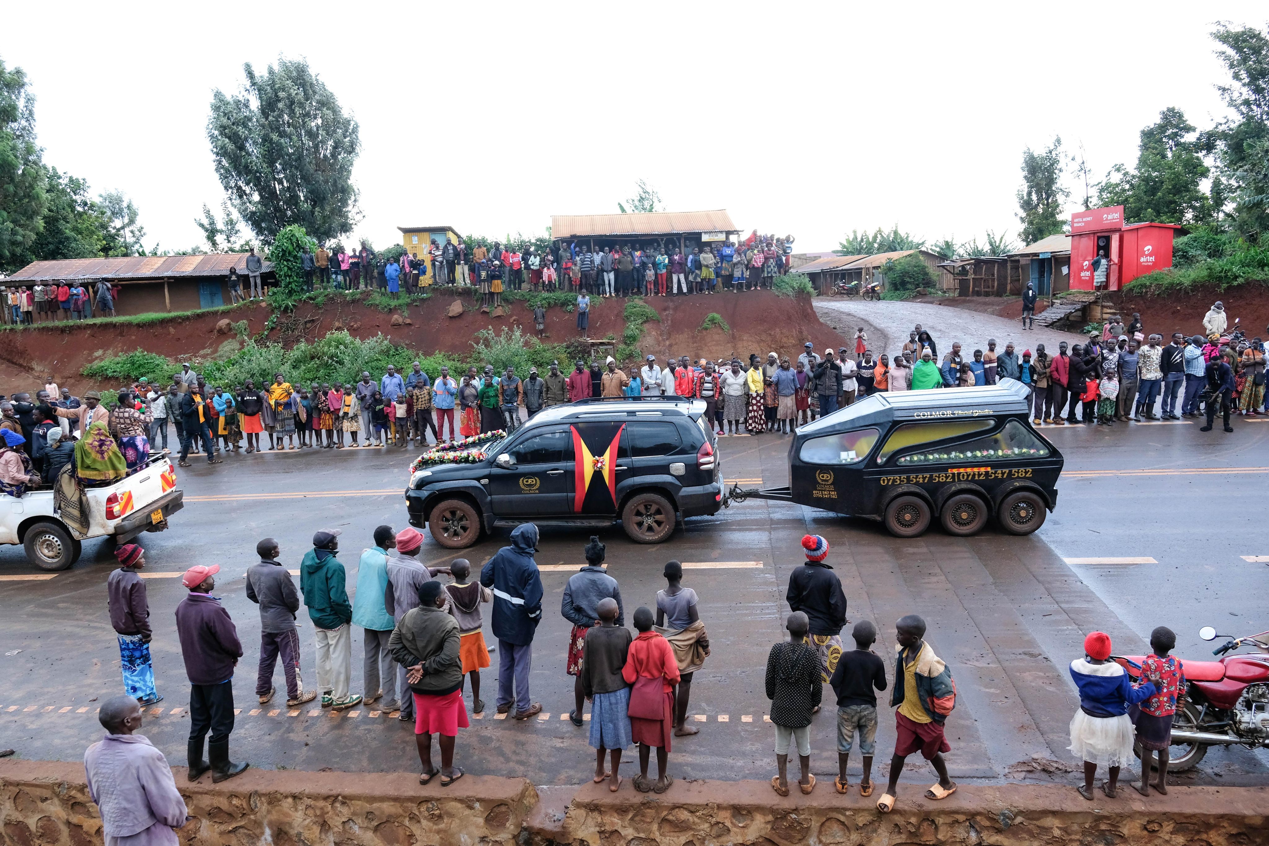 People stand on the roadside as the hearse carrying Olympian Rebecca Cheptegei’s coffin in Uganda. Photo: Xinhua