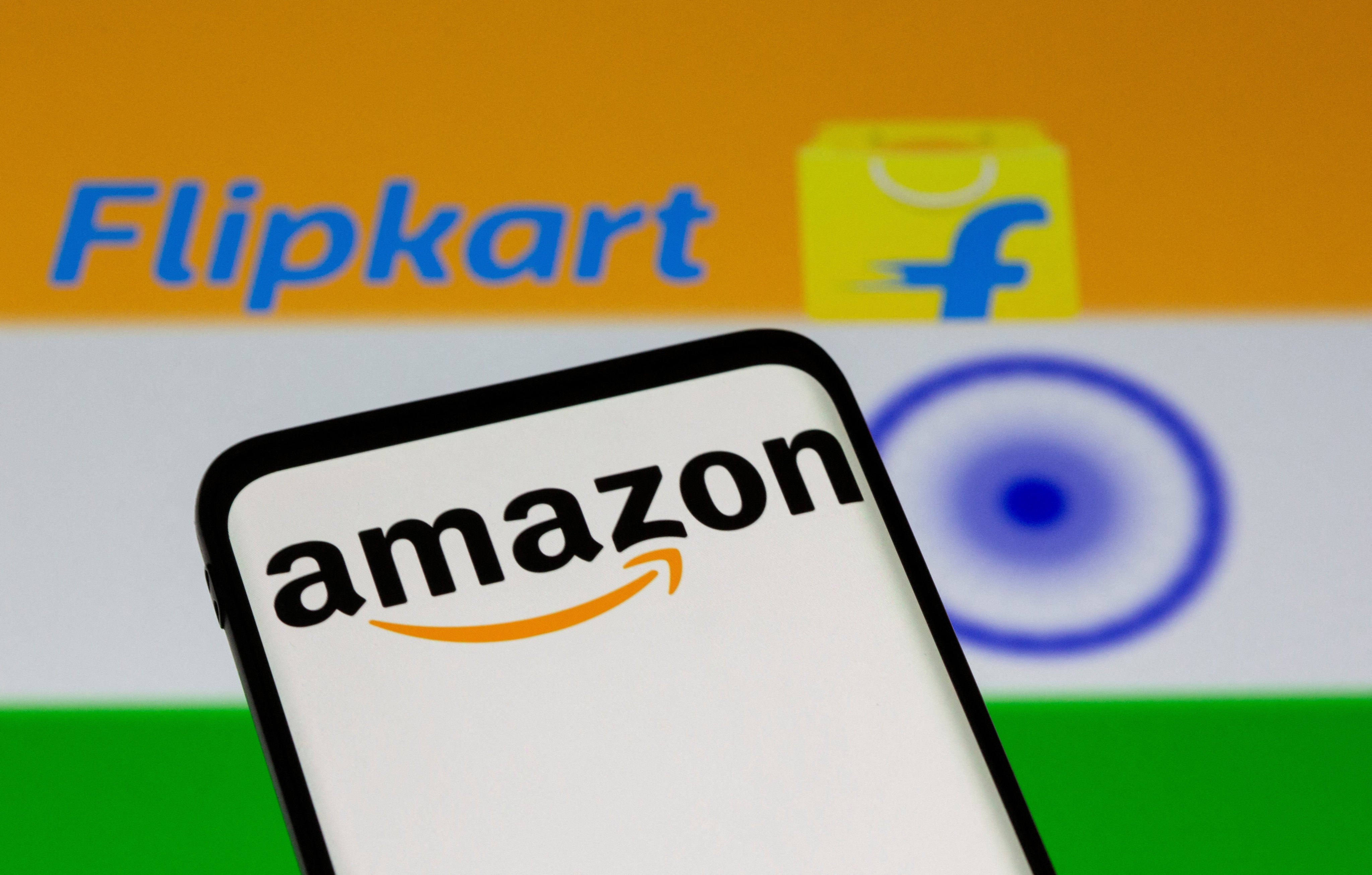 Smartphone with Amazon logo is seen in front of displayed Flipkart logo and Indian flag in this illustration. Photo: Reuters