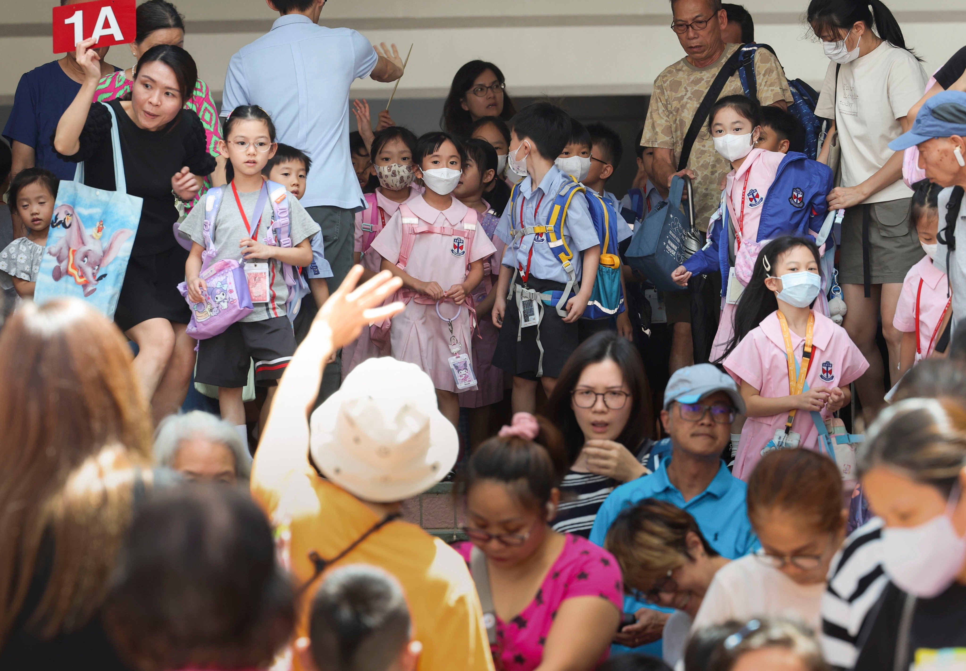 Children leave Taikoo Primary School in Quarry Bay on September 5. Dwindling numbers of students in primary schools across Hong Kong are leading education authorities to consolidate and shut down some schools. Photo: Dickson Lee