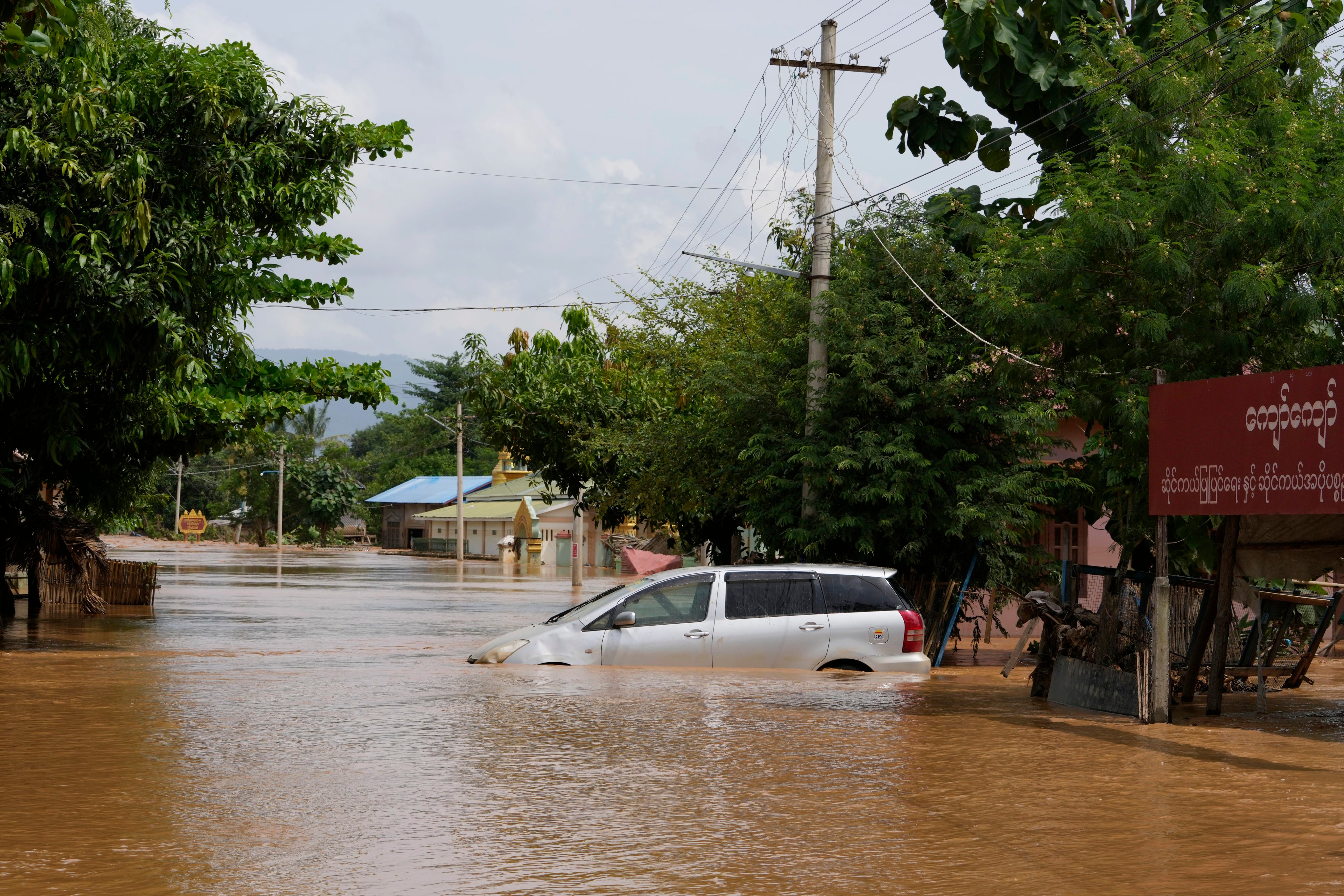 A car is submerged on a flooded road in Naypyitaw, Myanmar. At least 113 people have died in floods. Photo: AP