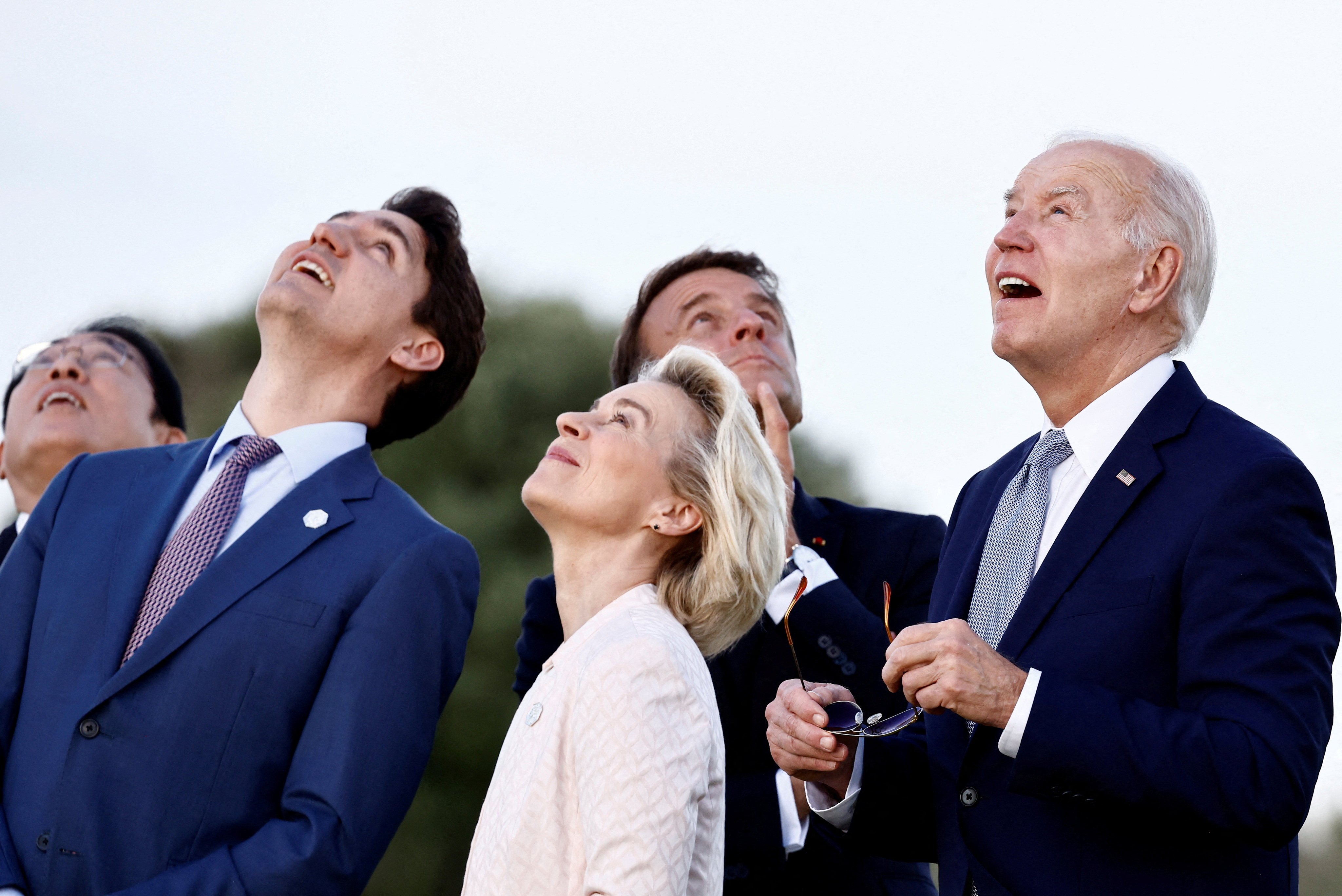 From left to right, Japanese Prime Minister Fumio Kishida, Canadian Prime Minister Justin Trudeau, European Commission President Ursula von der Leyen, French President Emmanuel Macron and US President Joe Biden observe a skydiving demonstration on the first day of the Group of Seven summit in Savelletri, Italy, on June 13. Photo: Reuters