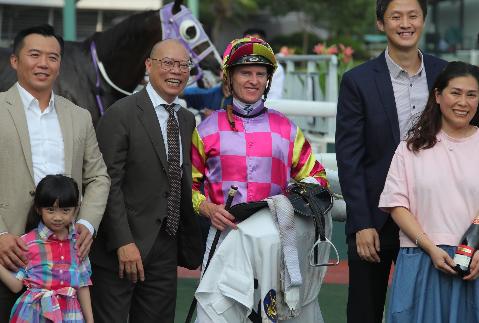 Trainer Chris So, jockey Zac Purton and connections after Super Win Dragon's victory.