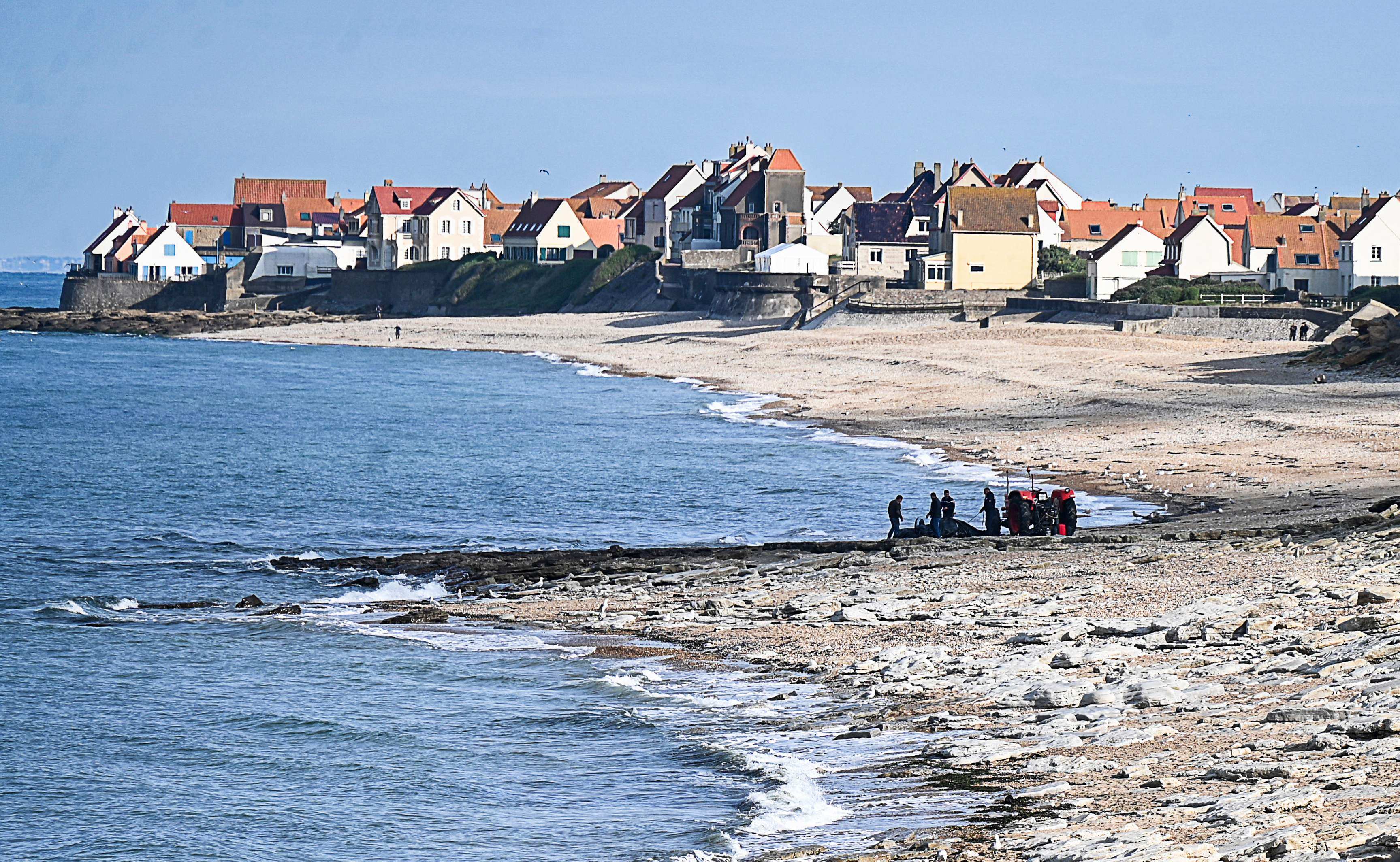 French police pull a damaged migrants’ boat from the sea after a failed attempt to cross the English Channel that led to the death of eight people on Sunday. Photo: AFP