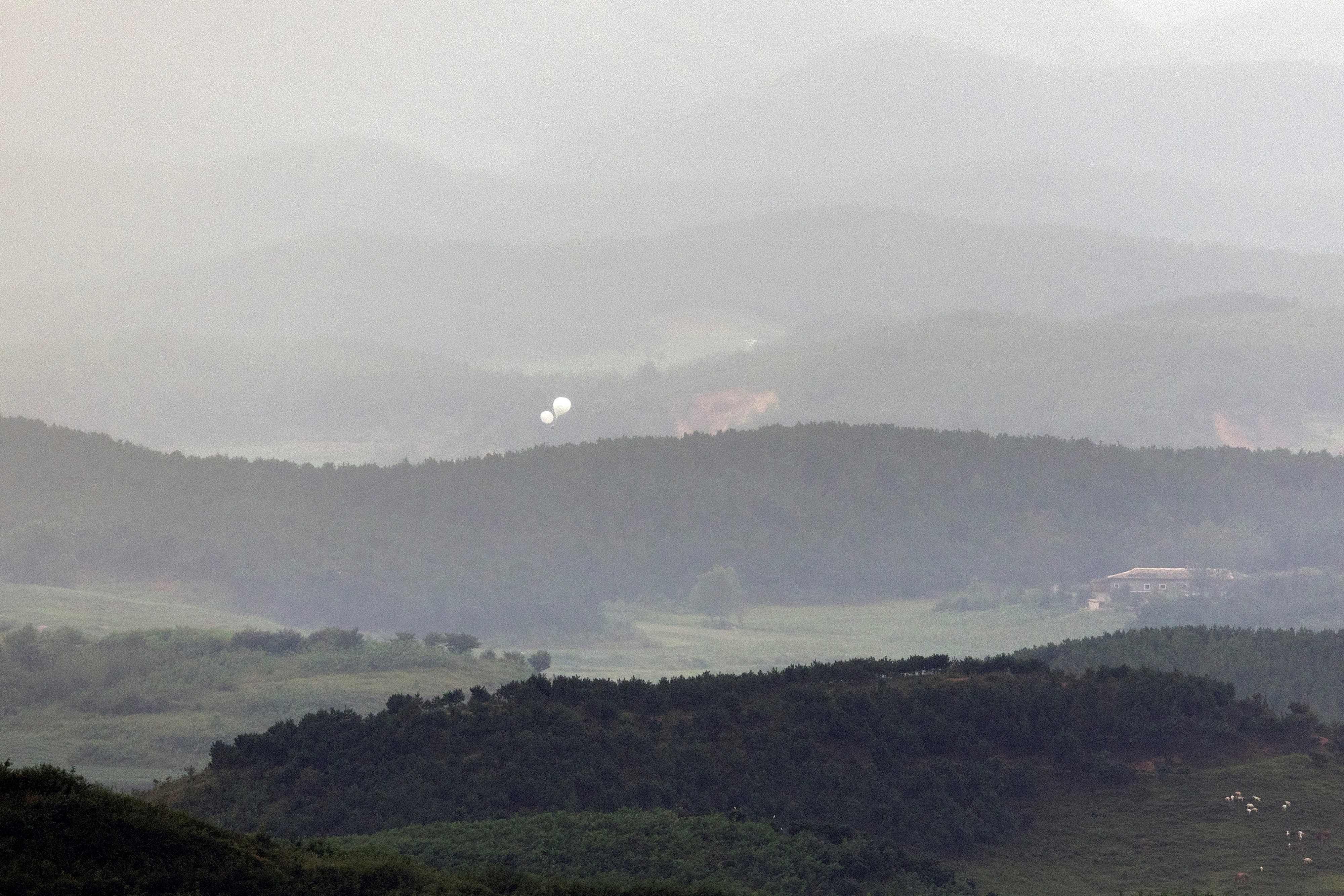 Balloons float over the border towards South Korea earlier this month. North Korea has sent more than 5,000 trash-filled balloons southwards since May. Photo: Yonhap/AFP