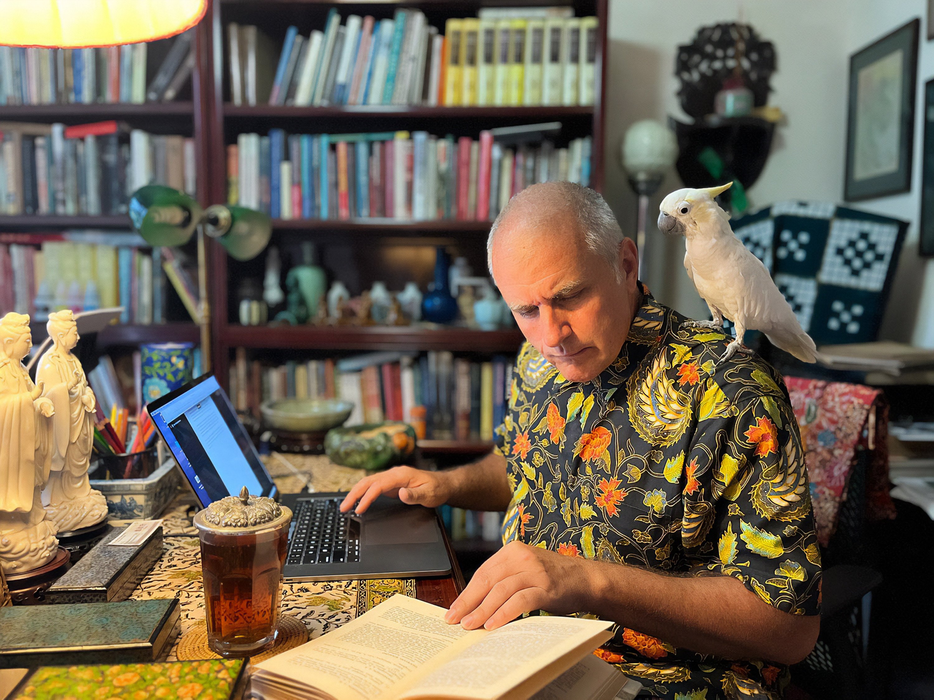 Jason Wordie at work, his pet parrot watching on, as he looks back over 25 years of covering the history and culture of Hong Kong. Photo: courtesy of Jason Wordie