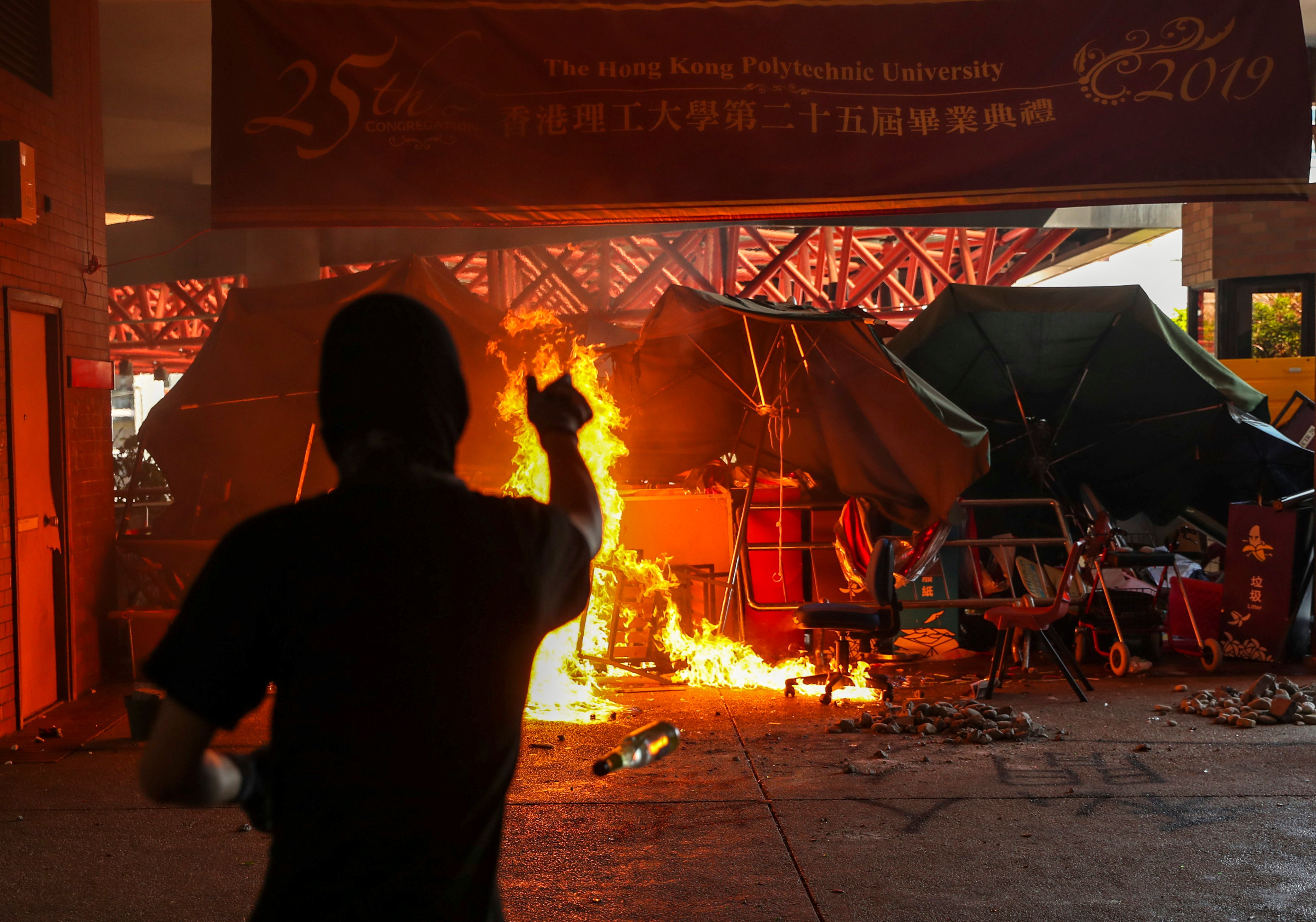 A protester sets fire and vandalizes facilities at the Polytechnic University in Hung Hom on November 11, 2019. Photo: Sam Tsang