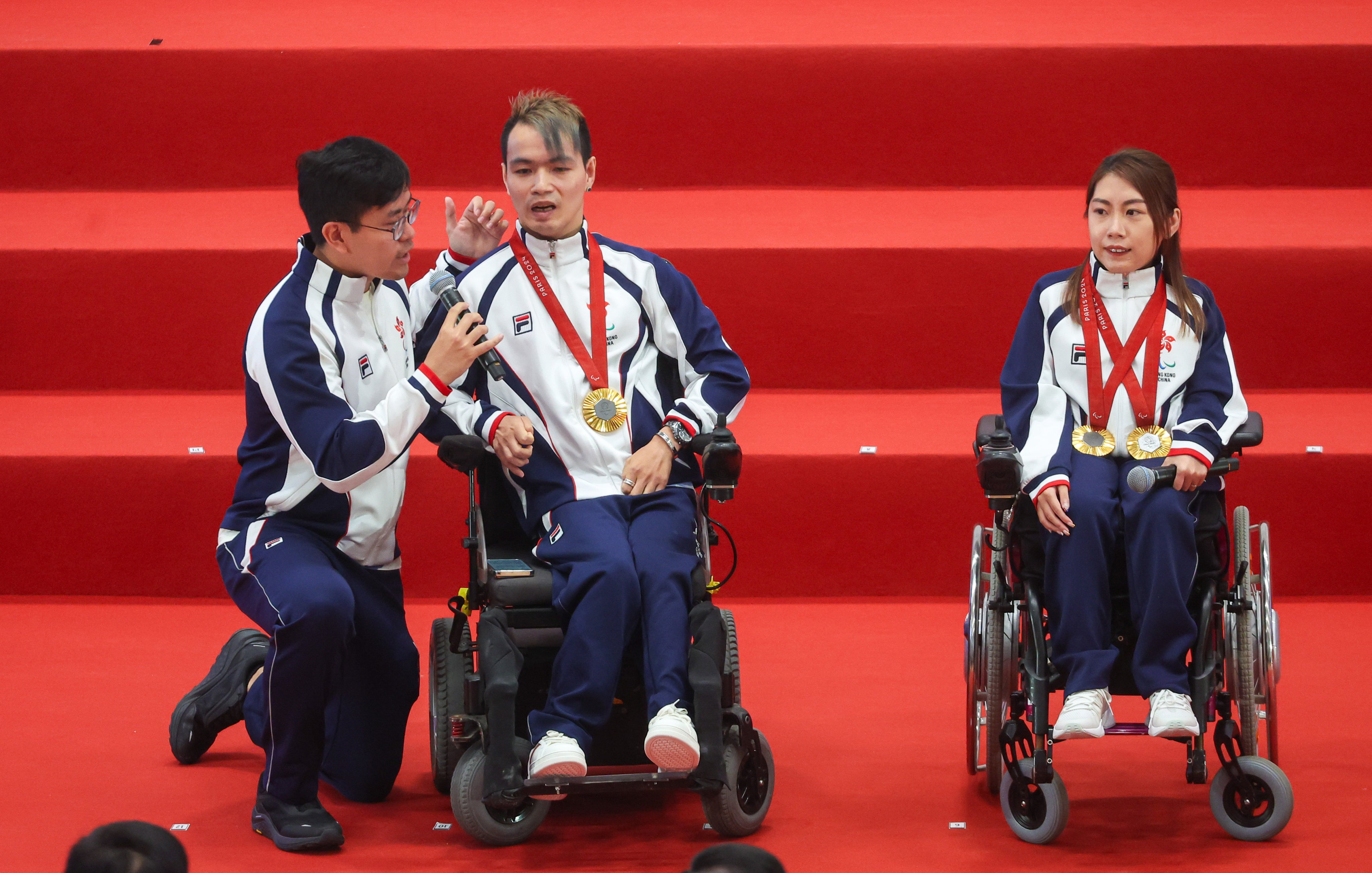 Boccia athletes John Loung (left) and Ho Yuen-kei answer questions during the welcome home ceremony at Ma On Shan Sports Centre. Photo: Edmond So