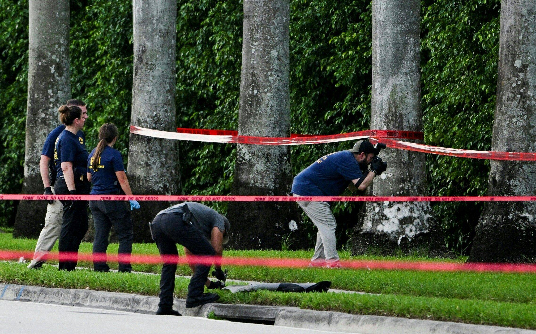 Members of the FBI at the scene outside the Trump International Golf Club in West Palm Beach, Florida. Photo: AFP