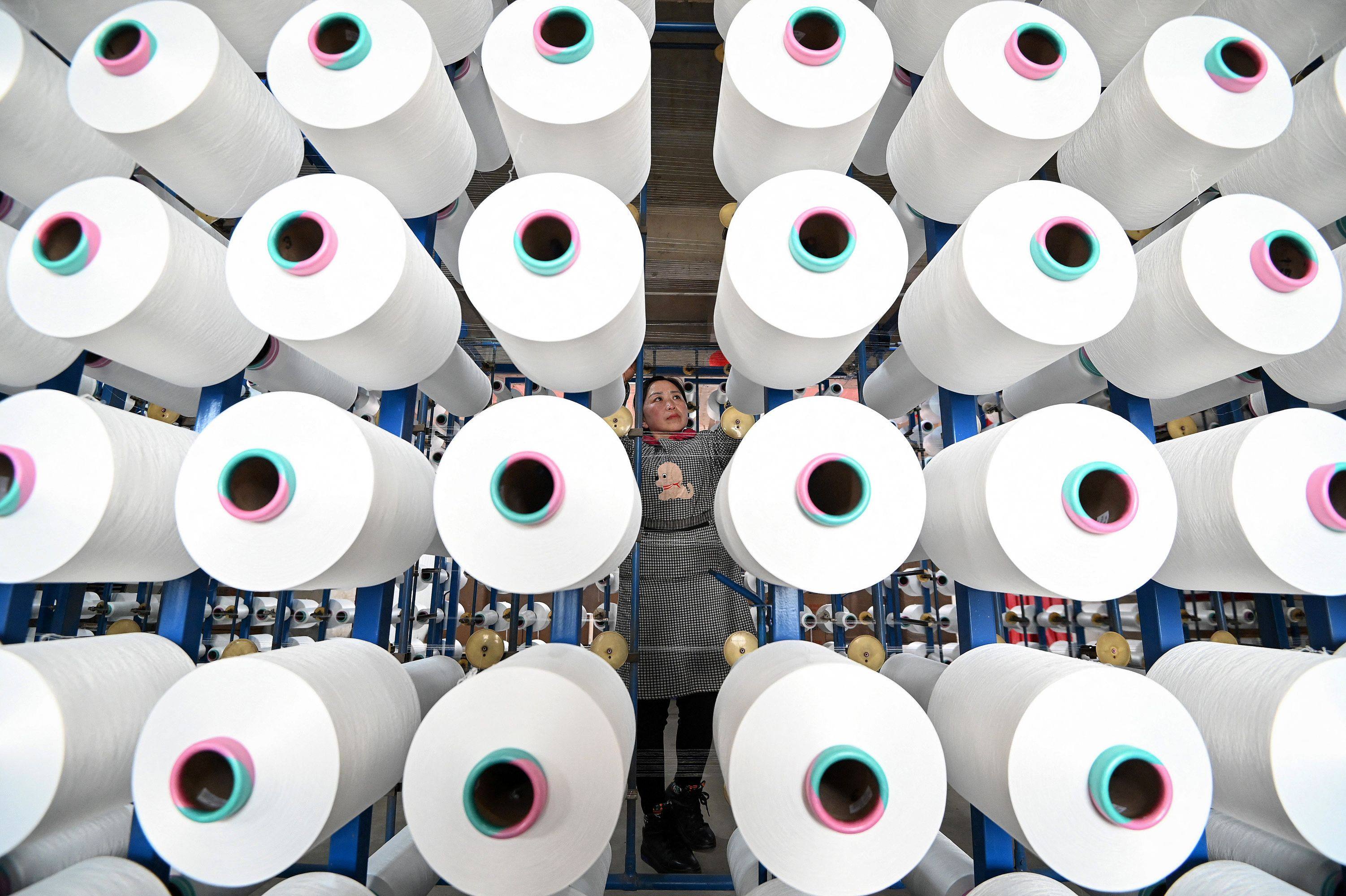 An employee checks cloth at a textile factory in Handan, in northern China’s Hebei province. Photo: AFP