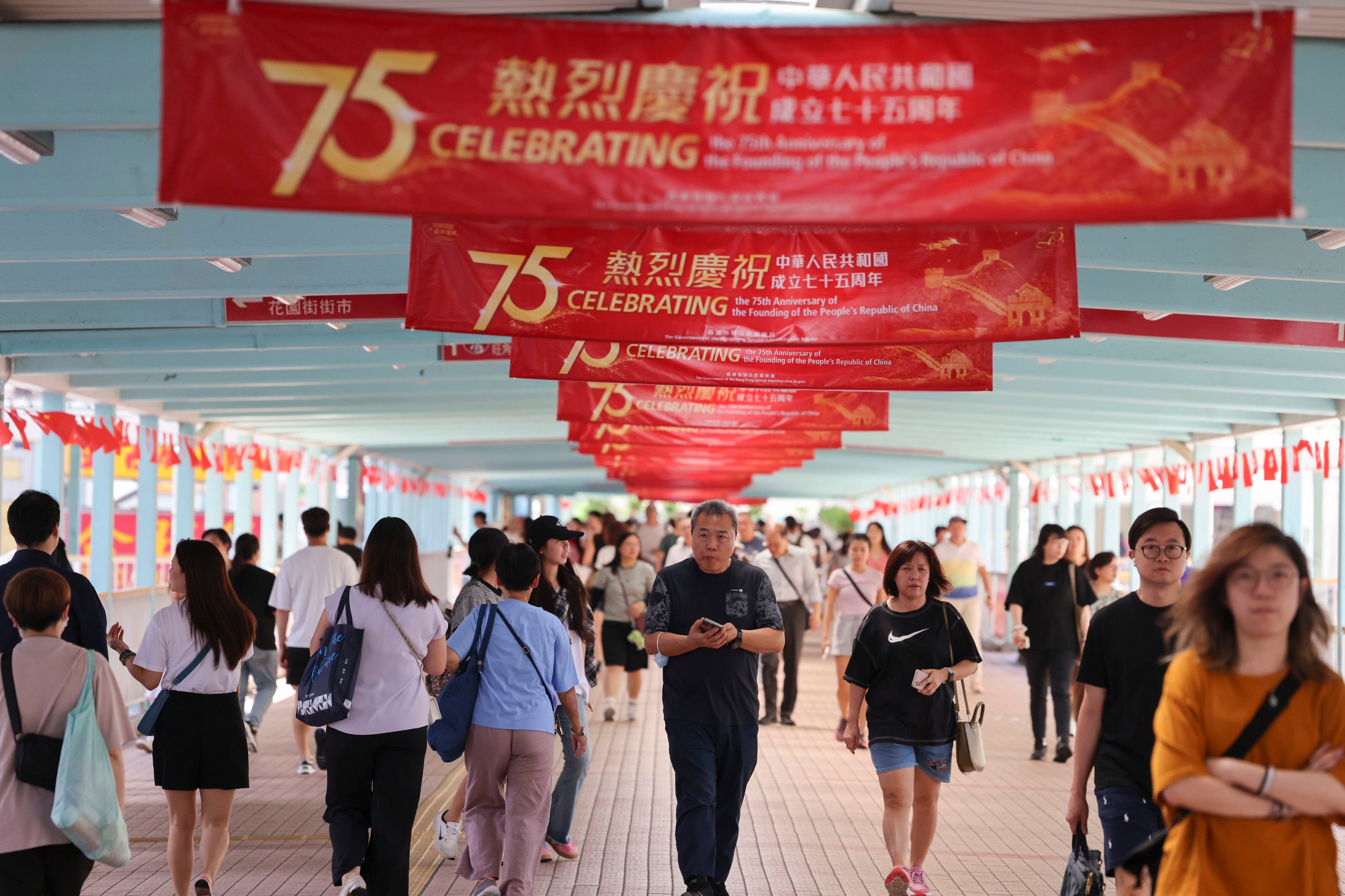 An overhead walkway in Mongkok is decorated with flags celebrating the 75th anniversary of the founding of the People’s Republic of China. Photo: Jelly Tse