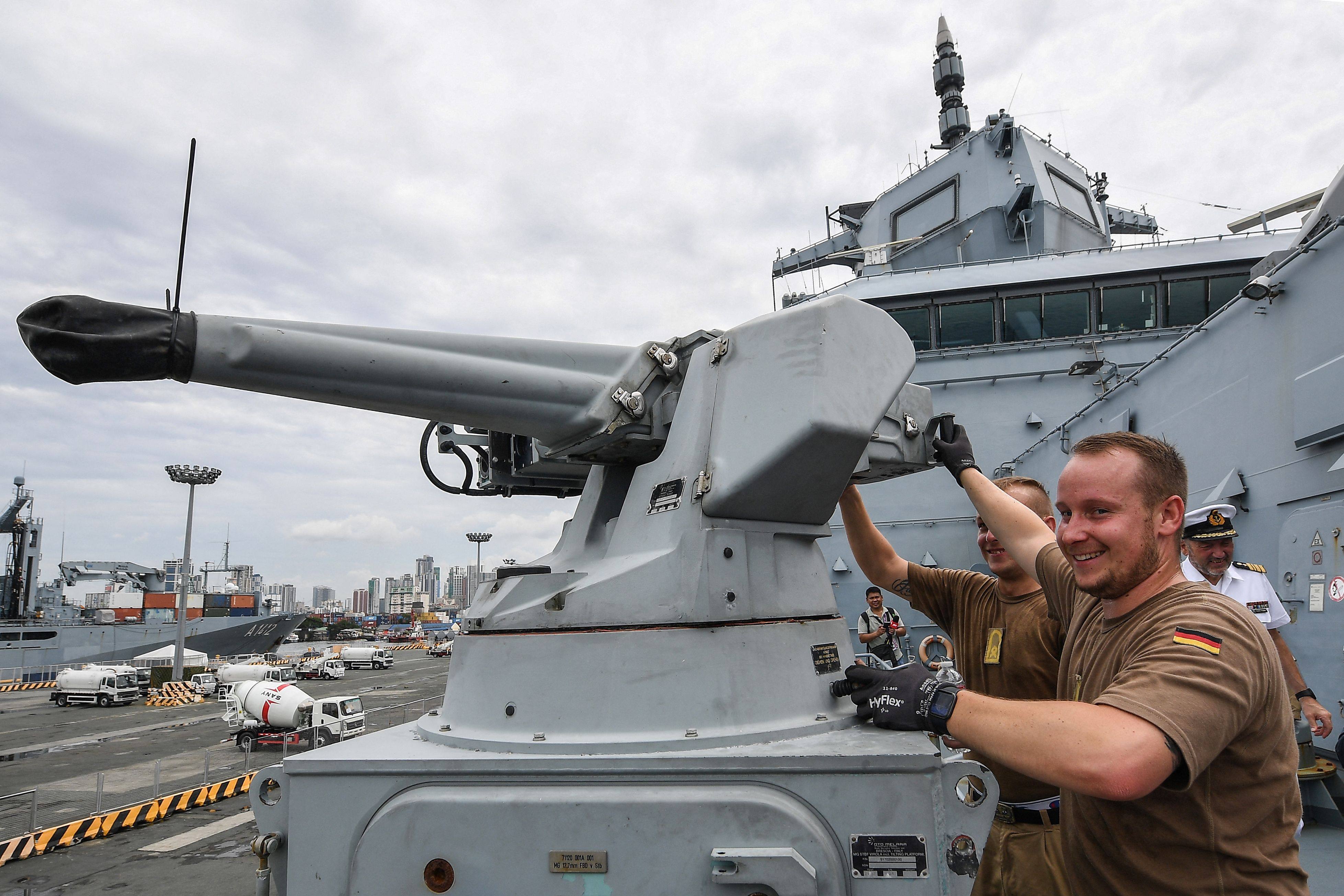 Sailors on board a German frigate check a machine gun after docking in Manila on Monday. Photo: AFP