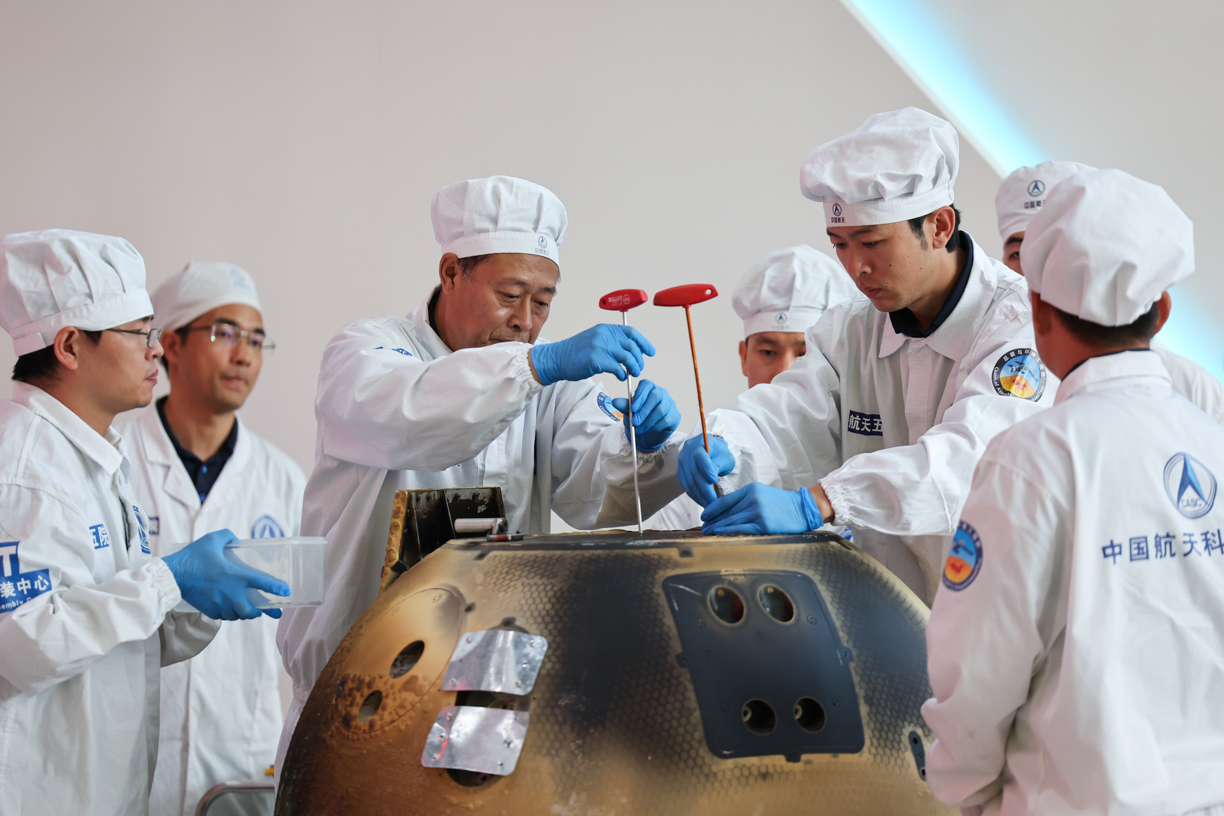 The return capsule of the Chang’e-6 lunar probe is opened during a ceremony at the China Academy of Space Technology under the China Aerospace Science and Technology Corporation in Beijing on June 26. Photo: Xinhua