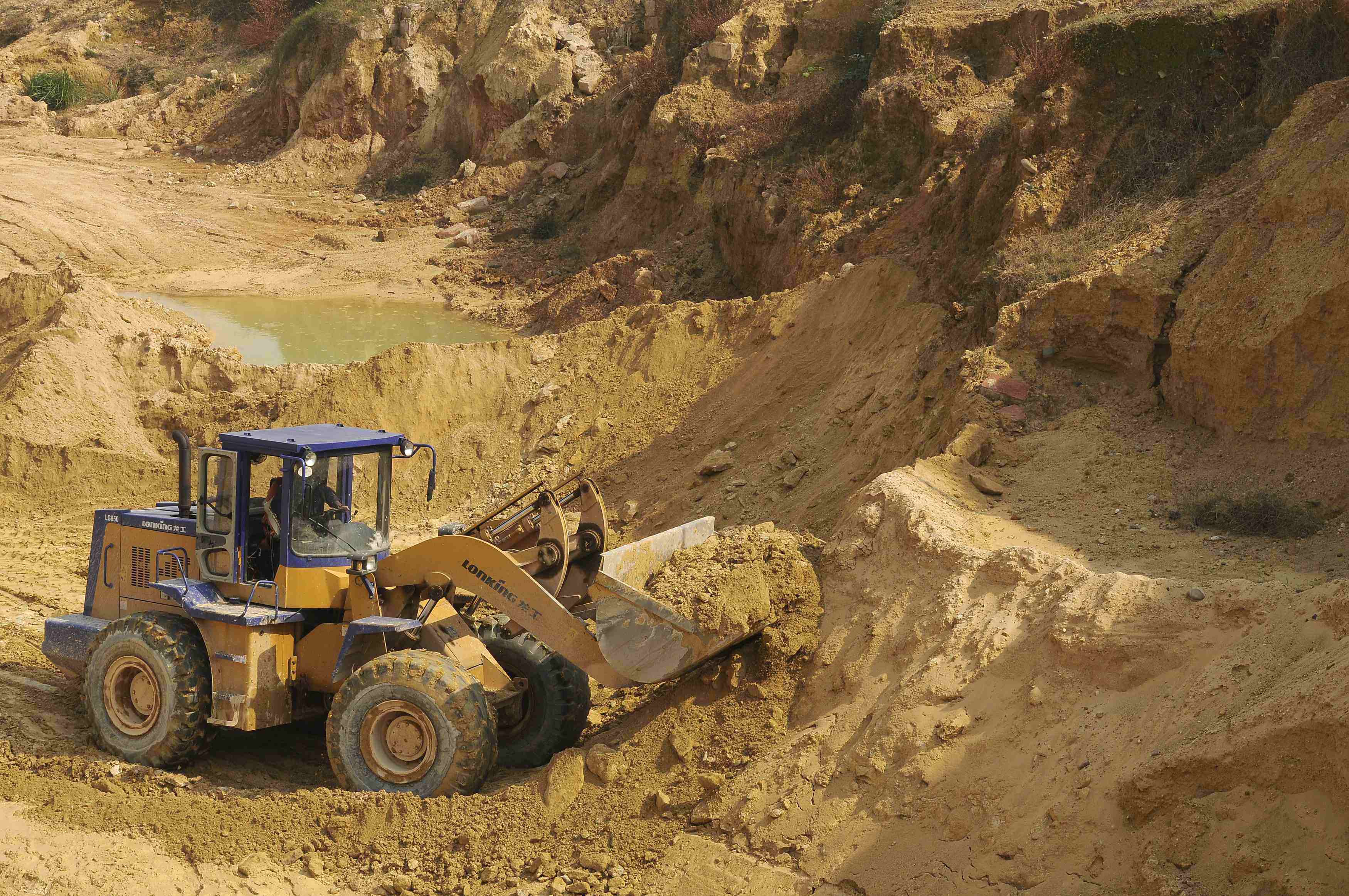 A worker drives a skip loader while working at the site of a rare earth metals mine at Nancheng county, Jiangxi province. Photo: Reuters