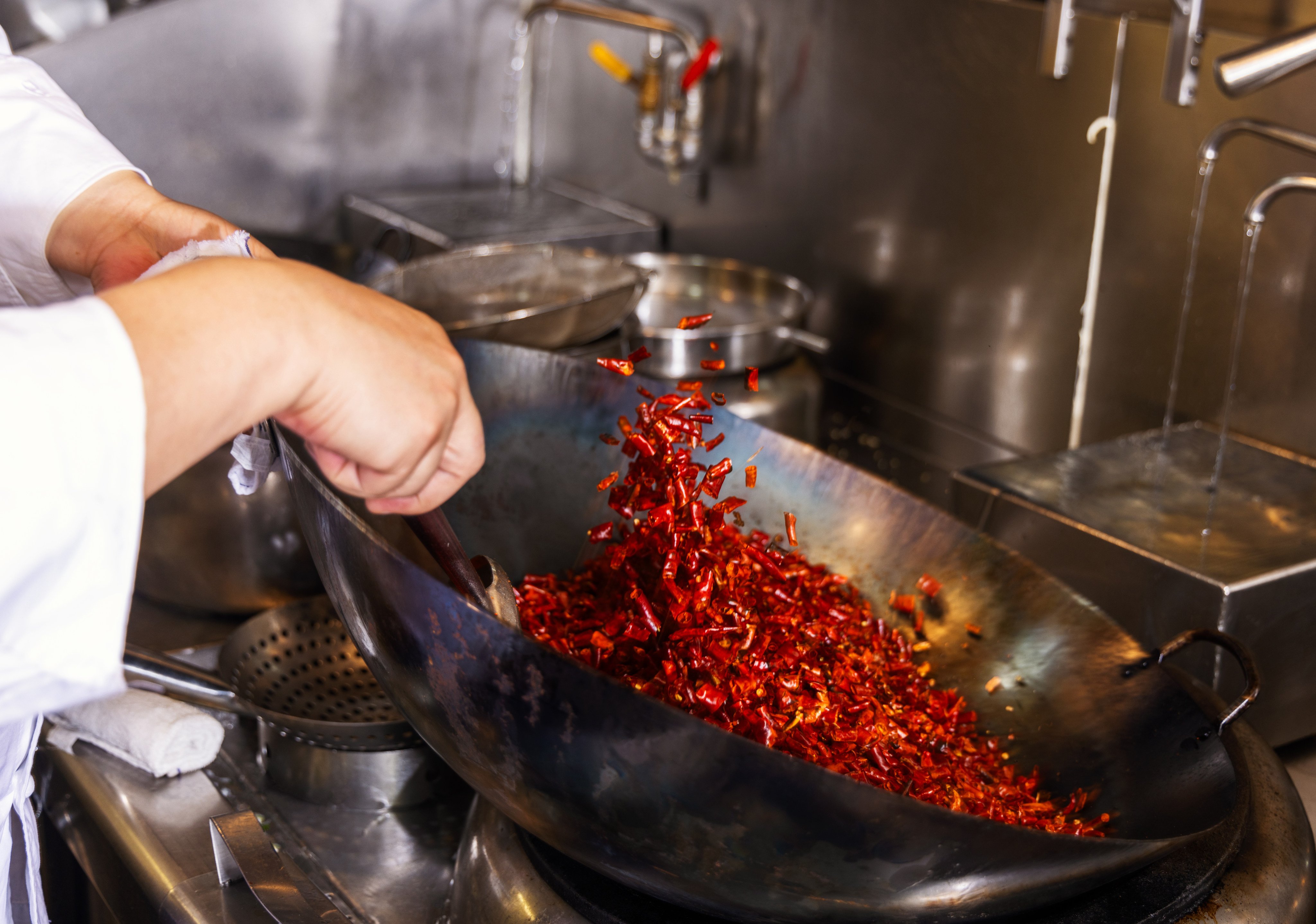 Ronald Shao, executive chef at Mian, at The Murray hotel in Hong Kong, cooks chilies to make the restaurant’s home-made chilli oil. Photo: Jocelyn Tam