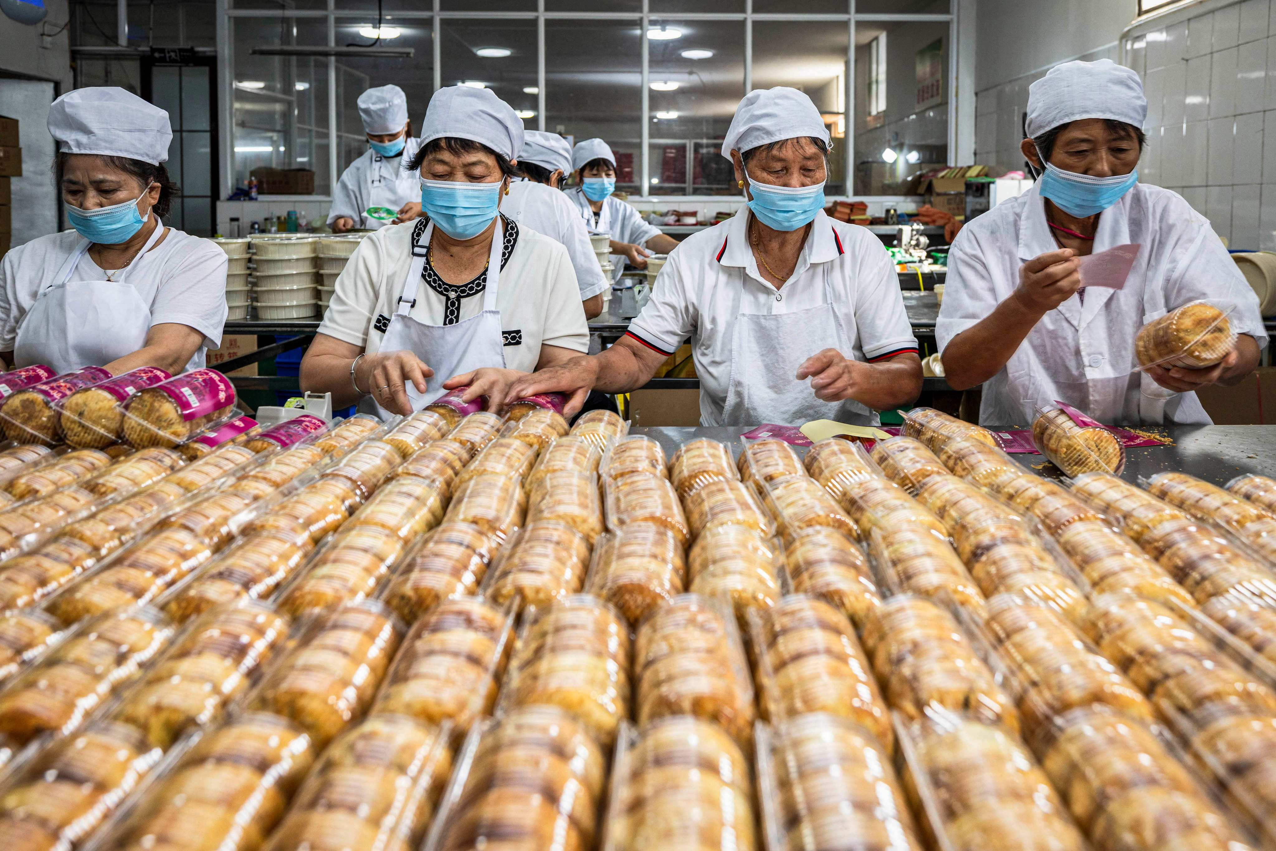 Factory employees make mooncakes ahead of the Mid-Autumn Festival in China’s Jiangsu province. Photo: AFP