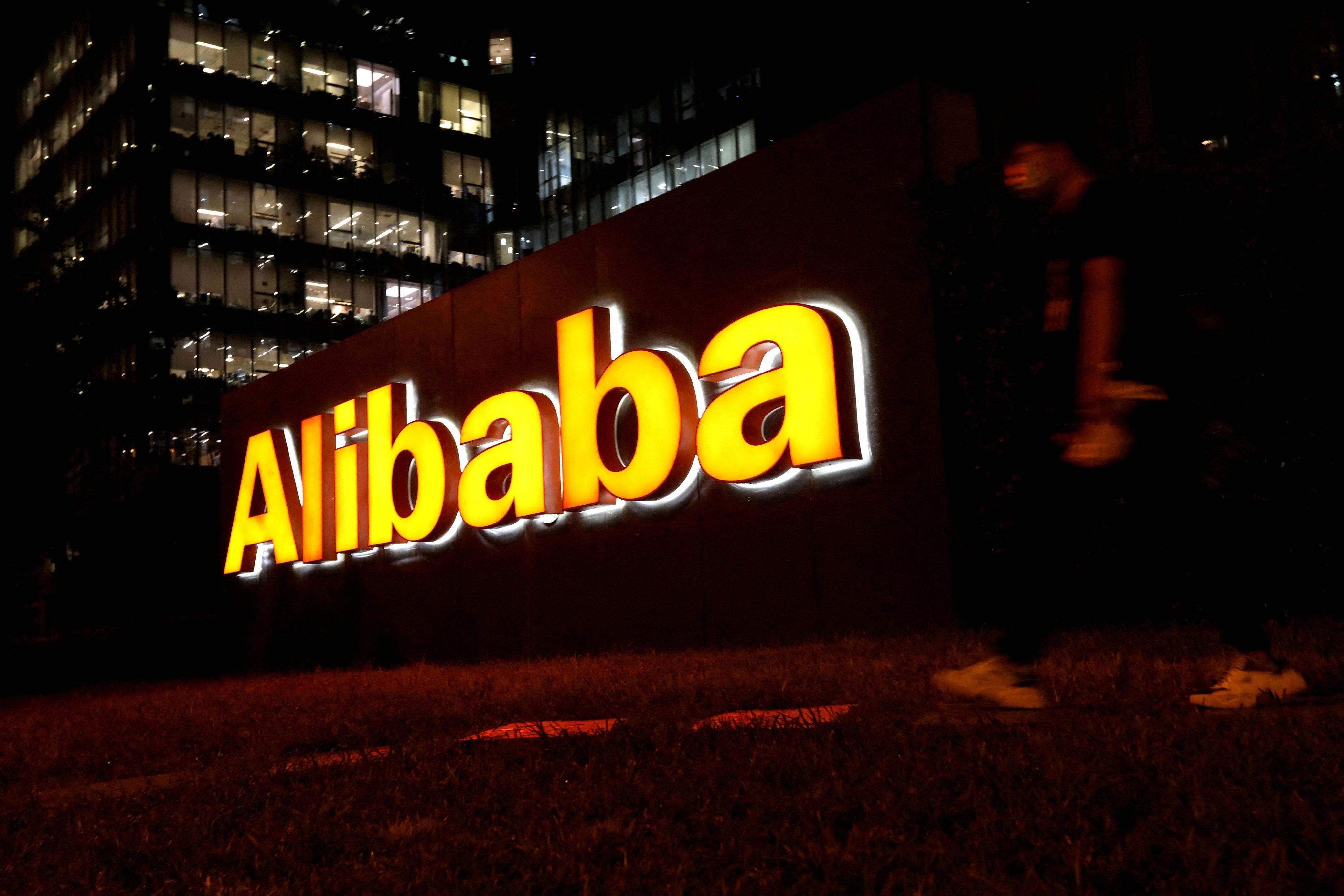 The logo of Alibaba is illuminated outside its office building in Beijing, China, August 9, 2021. Photo: Reuters