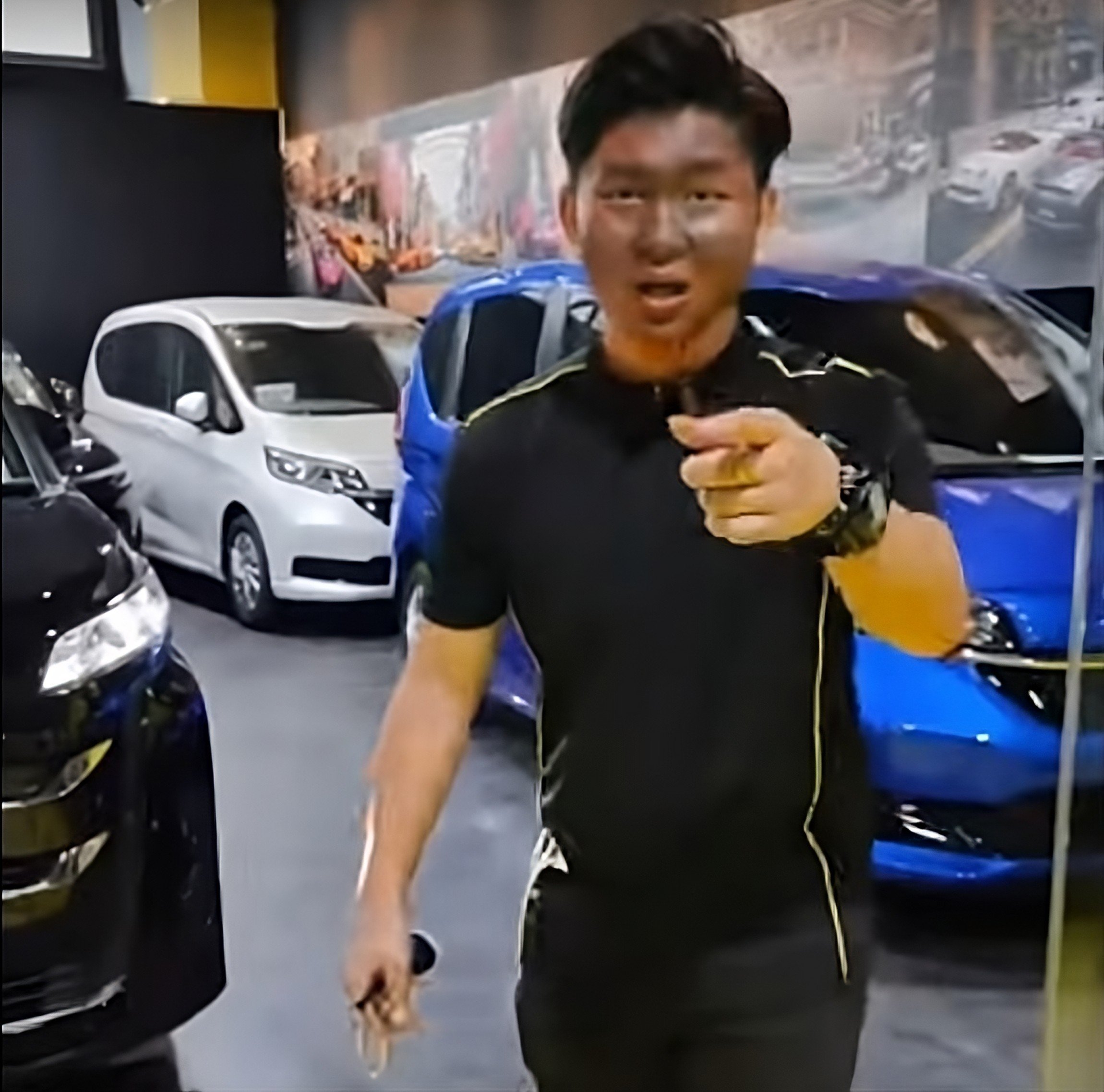 A salesman appears in blackface in an advert for JDM Automobile Carros Centre in Singapore. Photo: YouTube/WakeUpSingapore