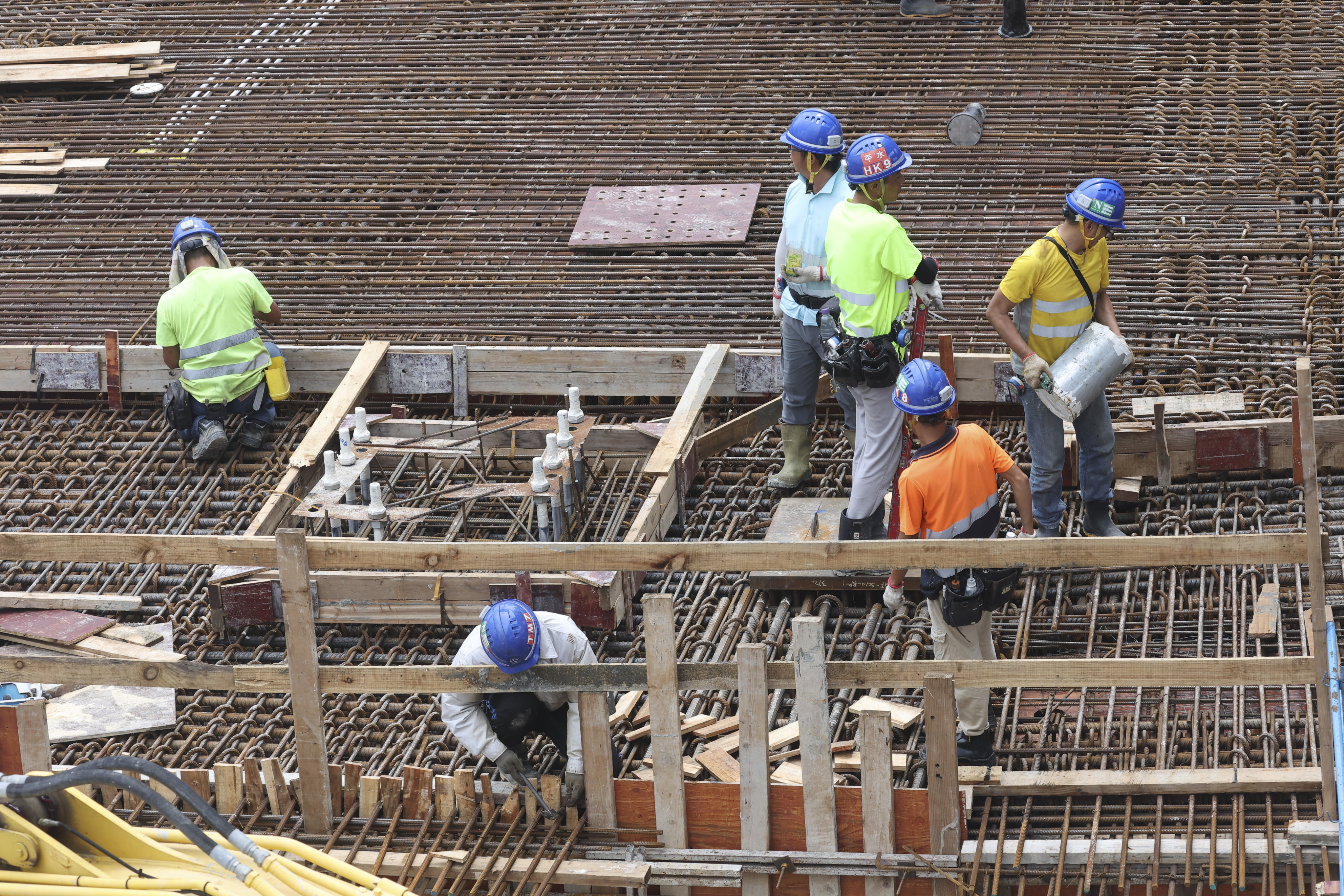 Construction workers are seen on a building site in Central, Hong Kong. Photo: Edmond So