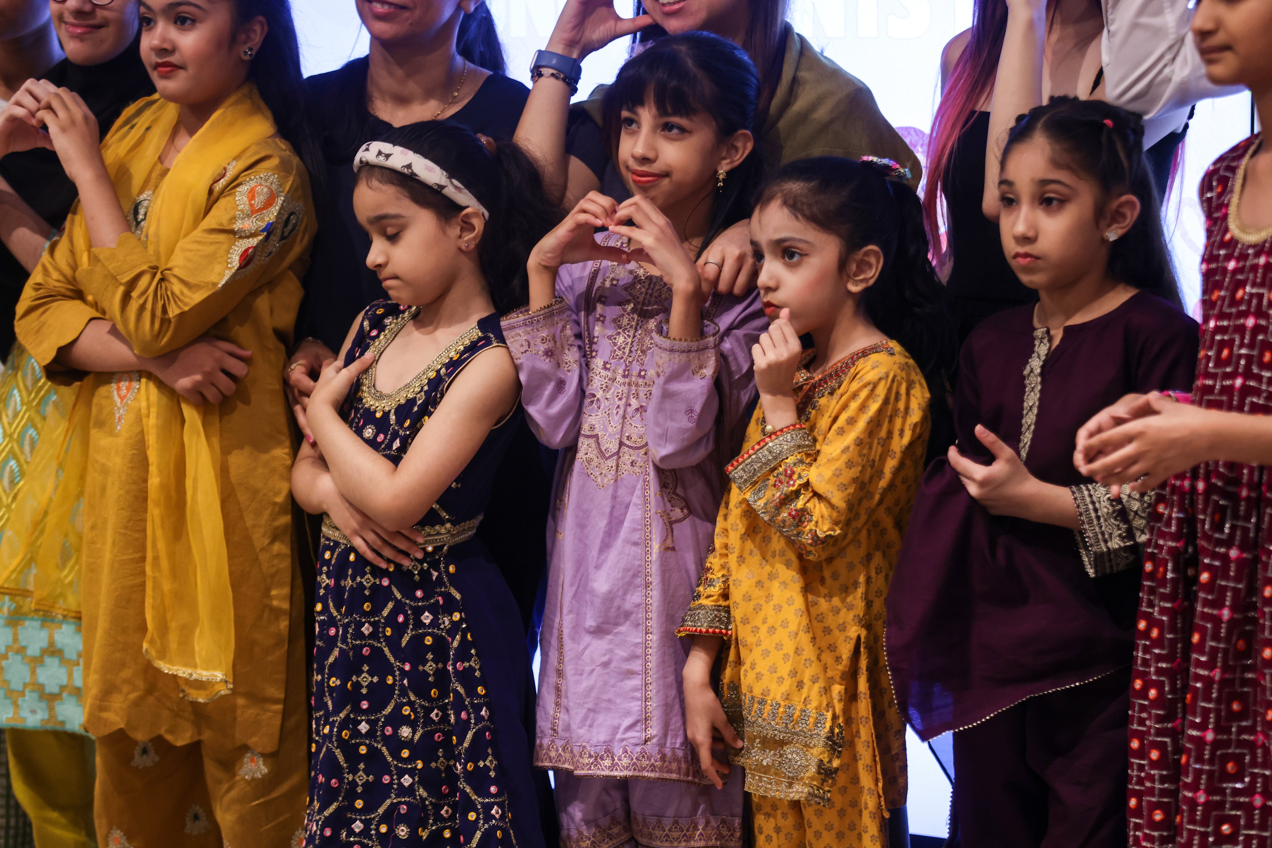 Children from ethnic minorities sing songs that help them learn Cantonese, while members of their parents’ generation who run businesses take part in a pop-up market  – examples of initiatives to help people from minorities integrate better in Hong Kong society. Photo: Jonathan Wong