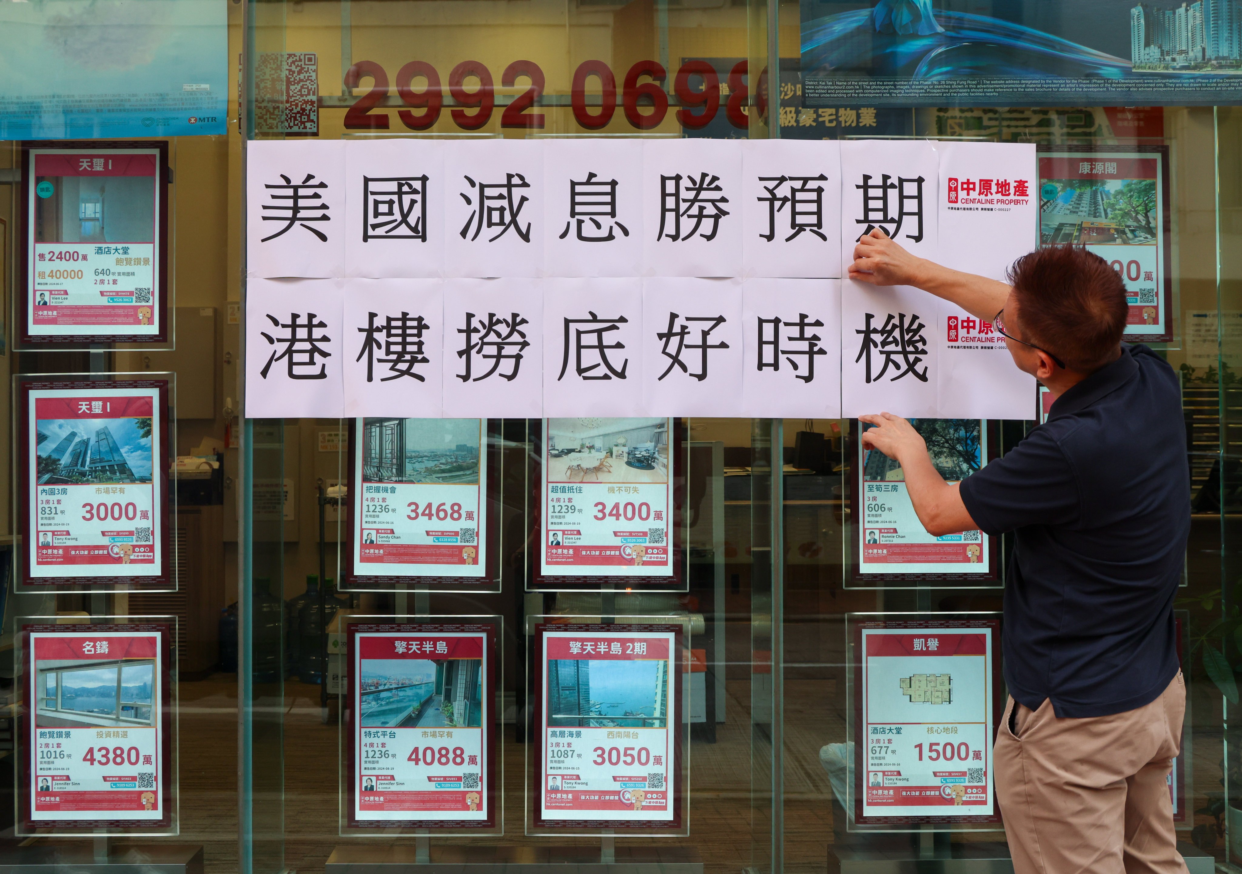 A real estate agent in Jordan posts a sign saying that it is a good time to enter the Hong Kong property market on September 19, after the first rate cut in four years. Photo: Jelly Tse