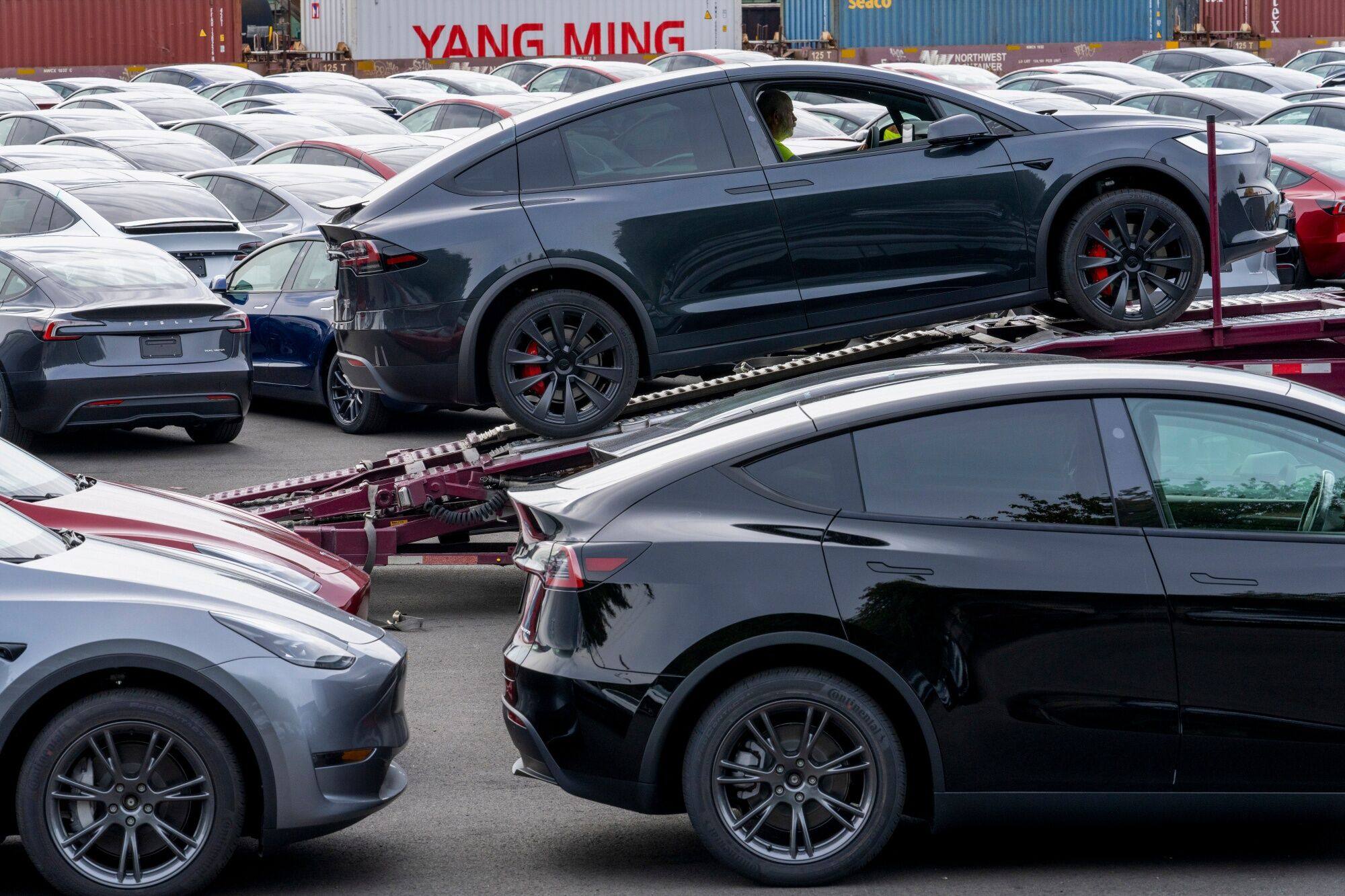 A Tesla Model X is positioned on a truck at a logistics drop zone in Seattle, Washington, in August. Although Tesla is one of the world’s largest sellers of EVs, this year it is well off its 2023 pace of 1.8 million deliveries. Photo: Bloomberg