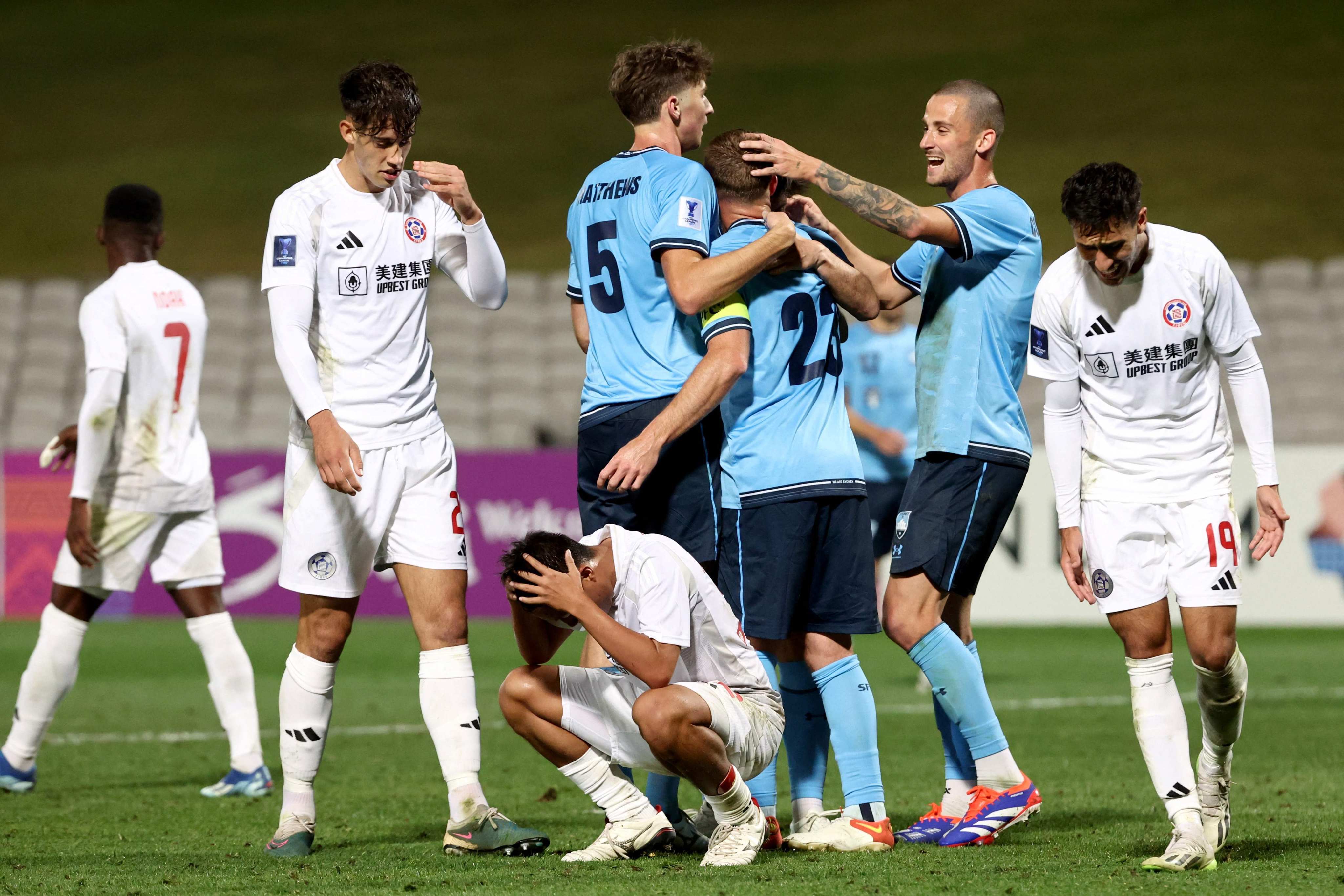 Eastern’s crestfallen players come to terms with conceding a cheap second goal to Sydney. Photo:  AFP