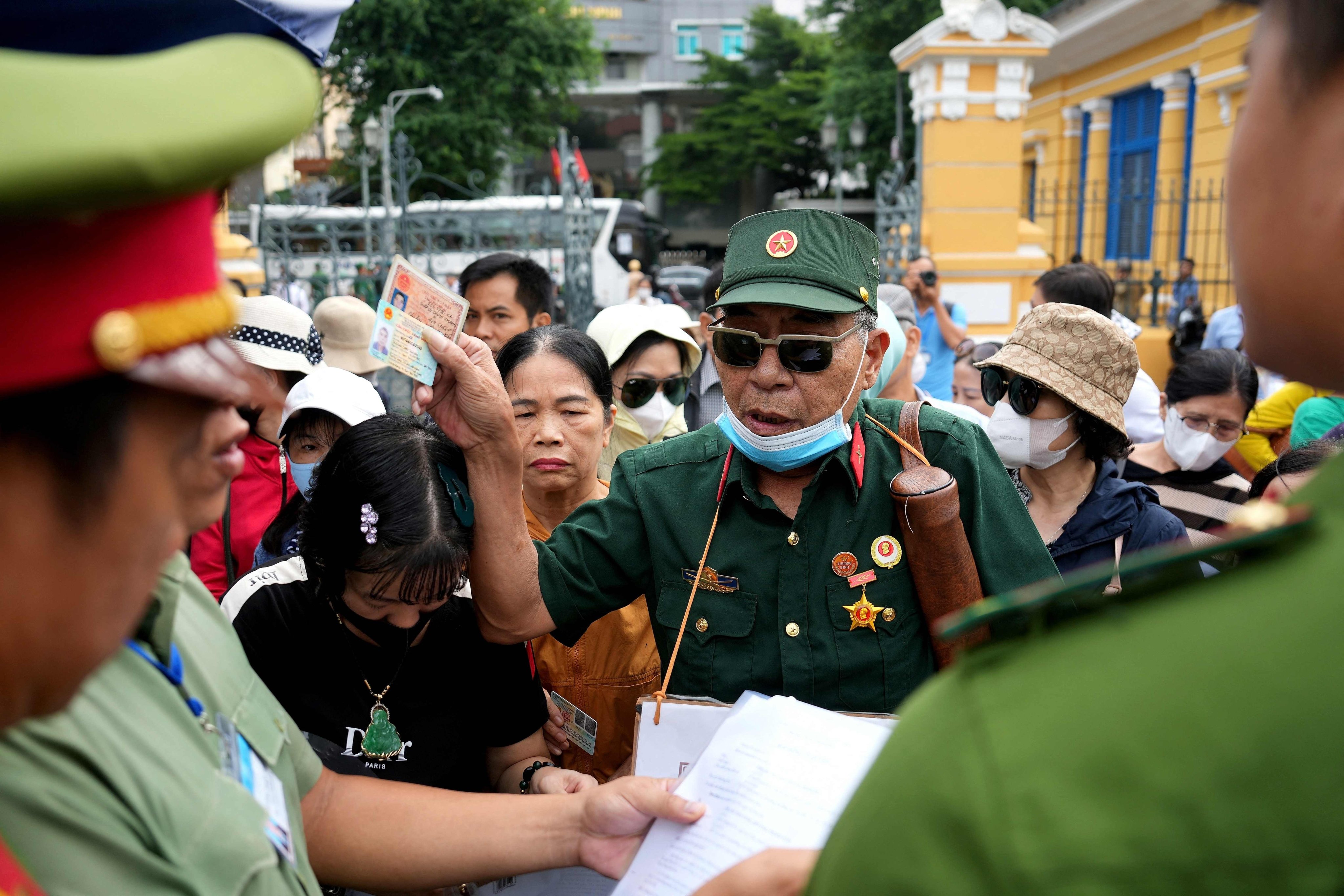 A Vietnam war veteran and fraud victim arrives with other victims to attend the court proceedings of Vietnamese property tycoon Truong My Lan in Ho Chi Minh City. Photo: AFP