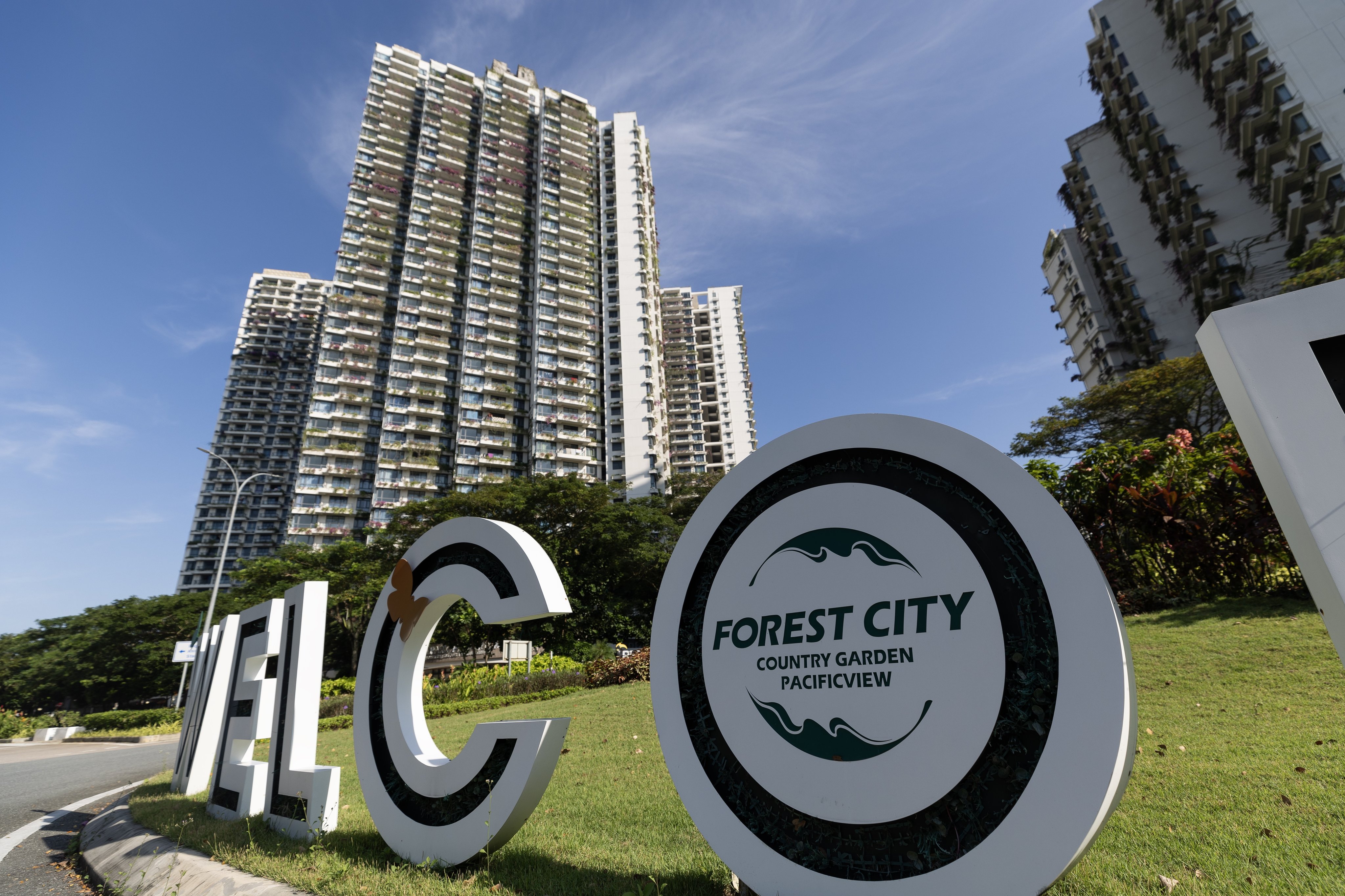 A welcome sign stands at a roundabout in front of residential apartments in Chinese developer Country Garden’s Forest City in Johor Bahru, Malaysia. Photo: EPA-EFE