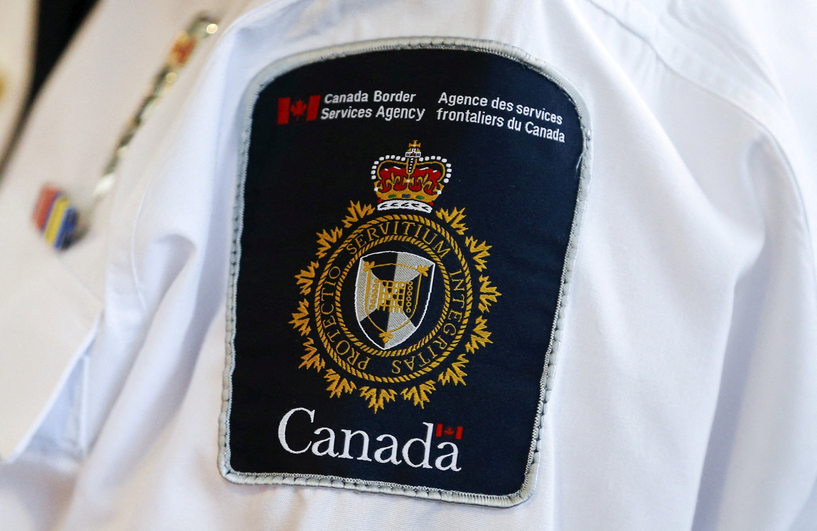 A Canada Border Services Agency logo is seen on a worker at Toronto Pearson International Airport. Photo: Reuters