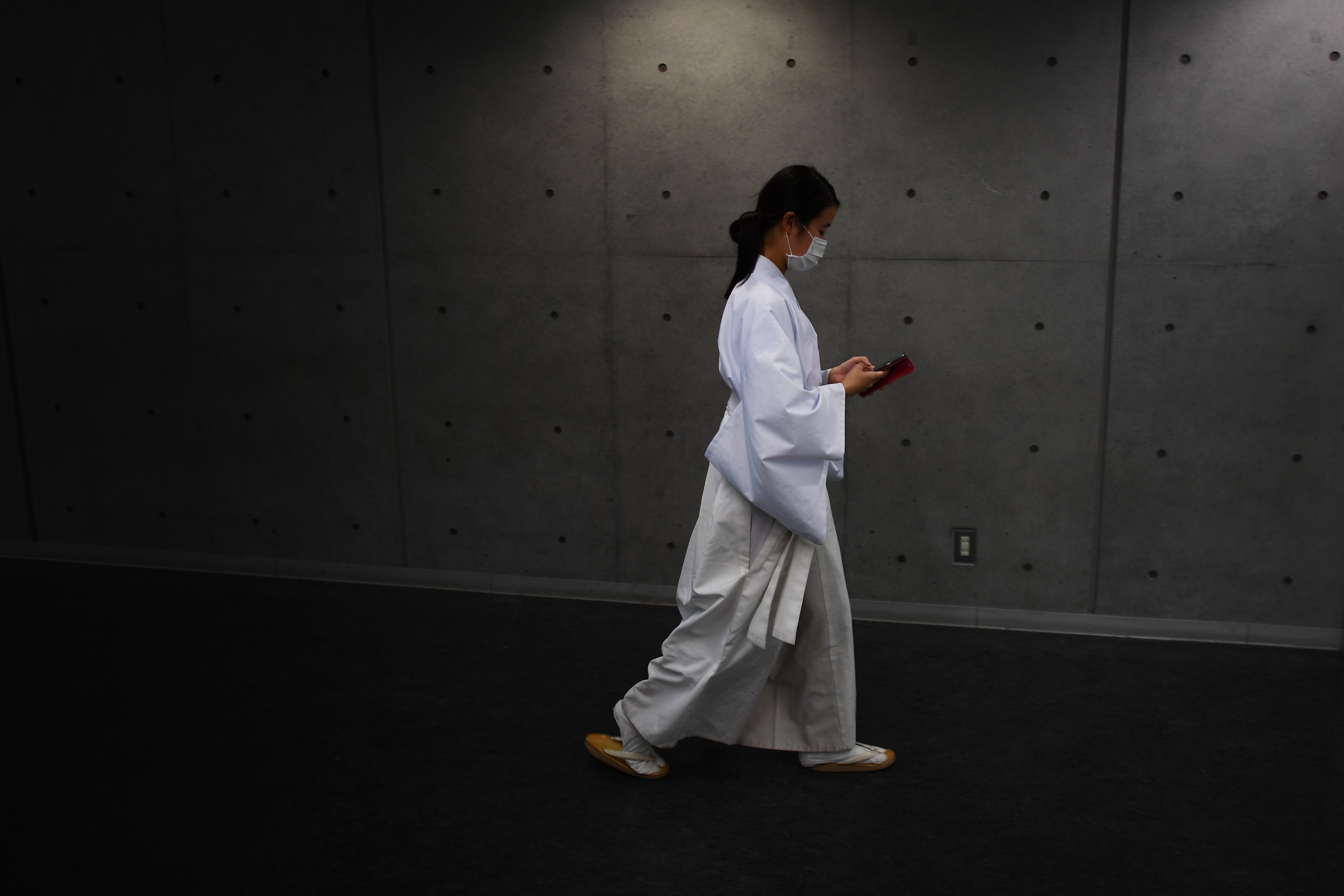 A woman walks down a corridor before a coming-of-age ceremony at a university in Tokyo on January 11, 2020. Photo: AFP