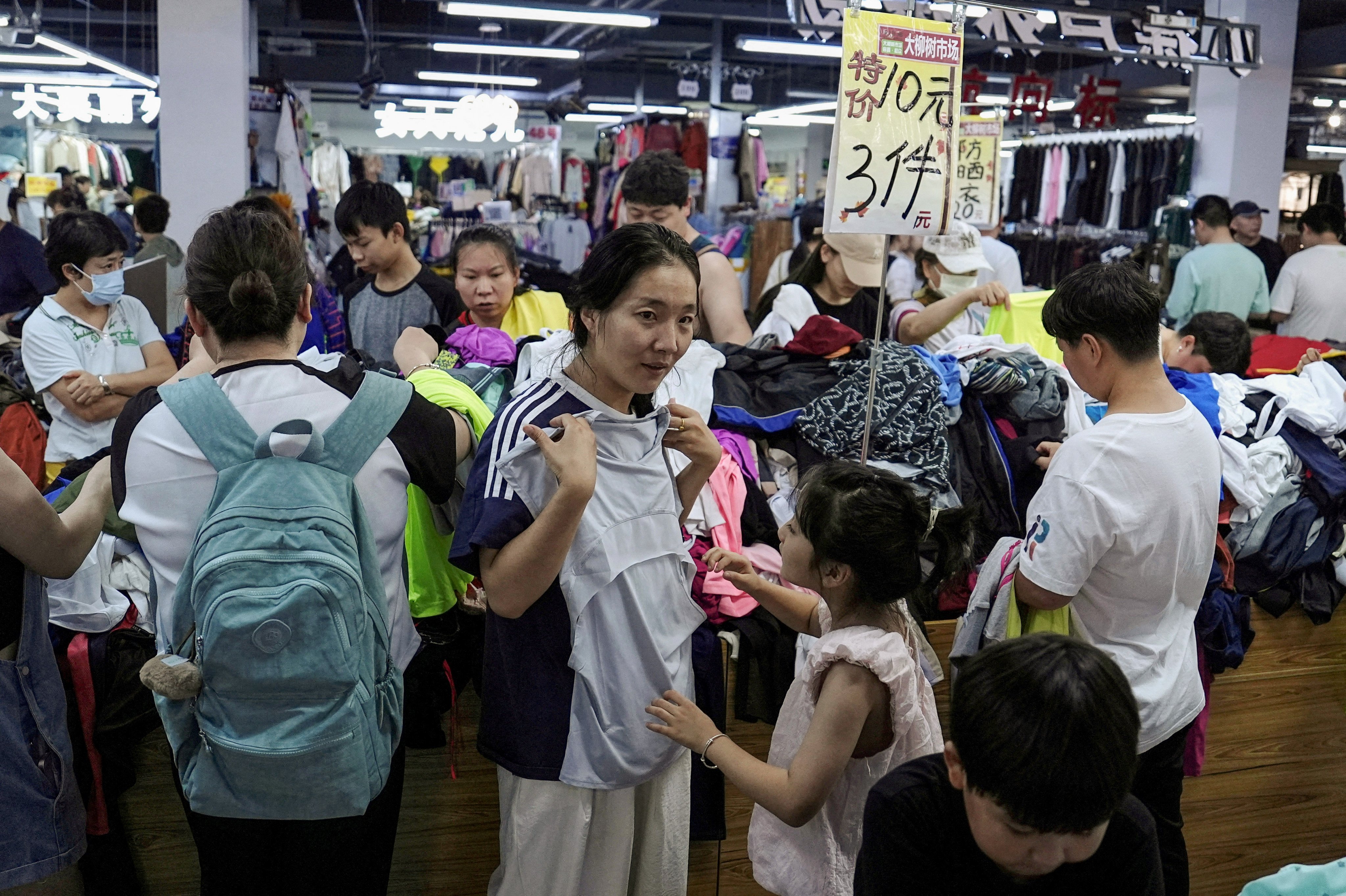 Customers shop at a discount clothing shop in Beijing. A hitch in domestic demand has become a stumbling block for China’s economic growth. Photo: Reuters