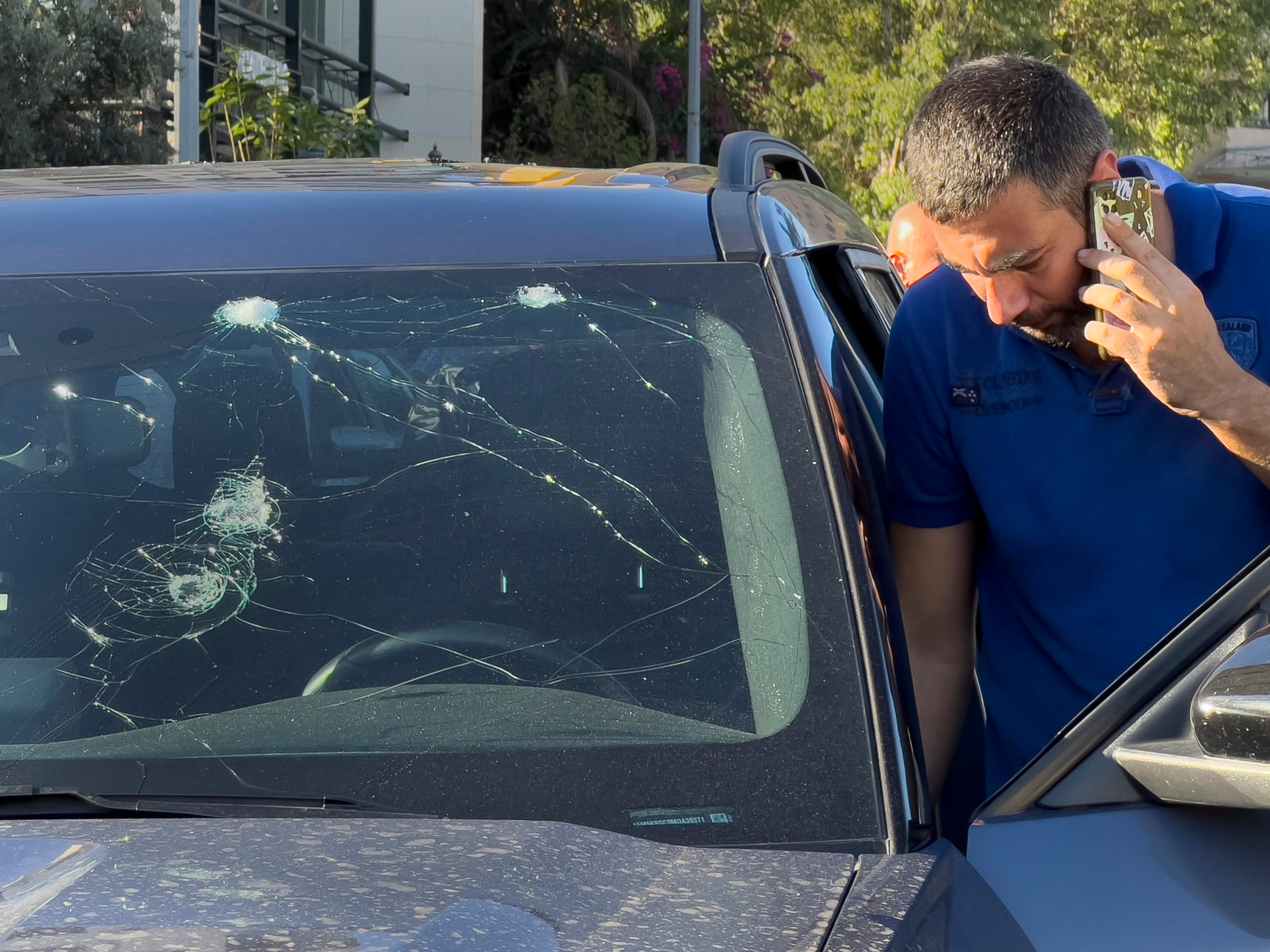 A police officer looks at a car in which a hand-held pager exploded in Beirut on Tuesday. Photo: AP