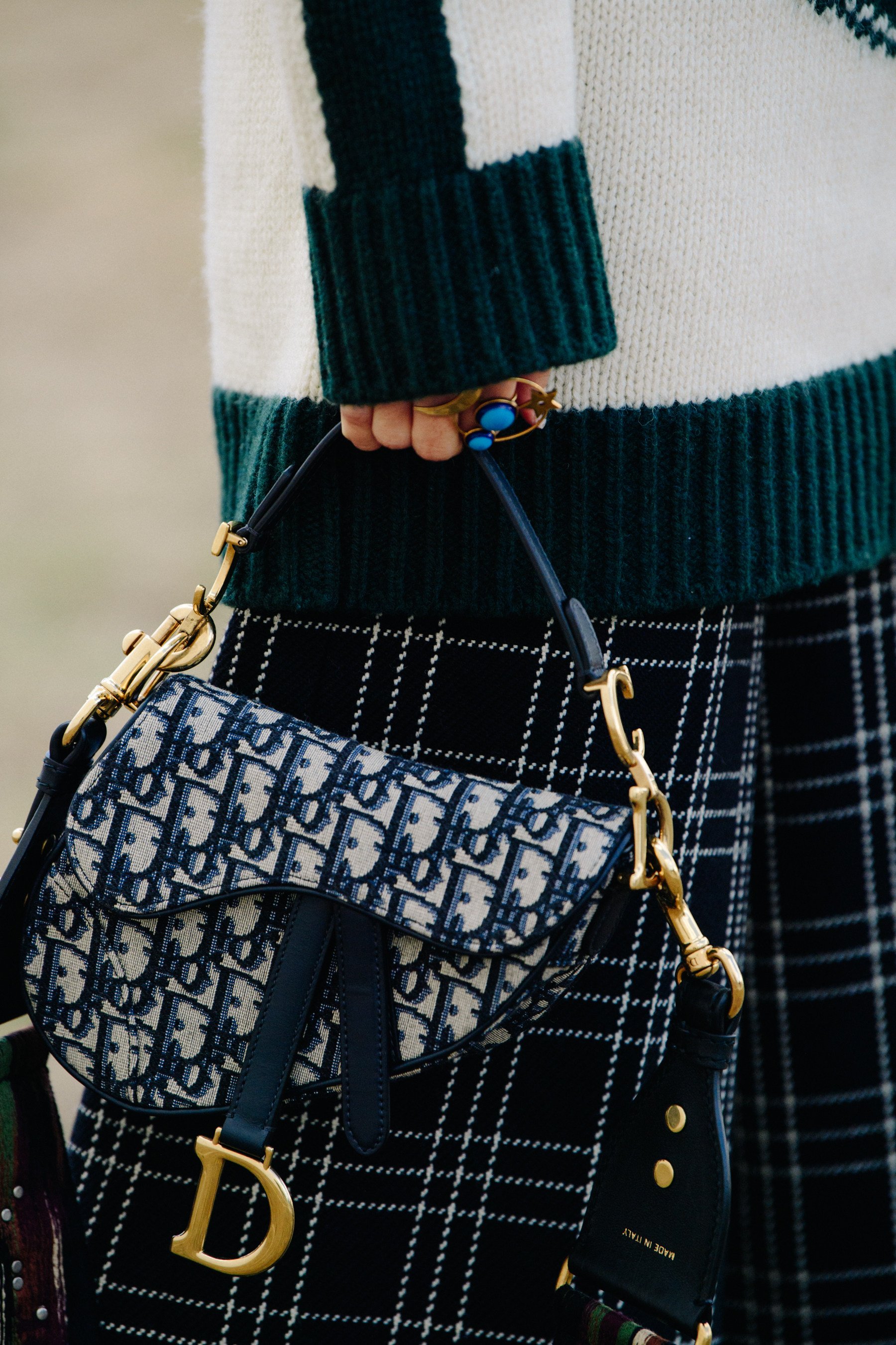 A guest carries a Dior Saddle bag at the Dior spring/summer 2019 show in Paris, France.