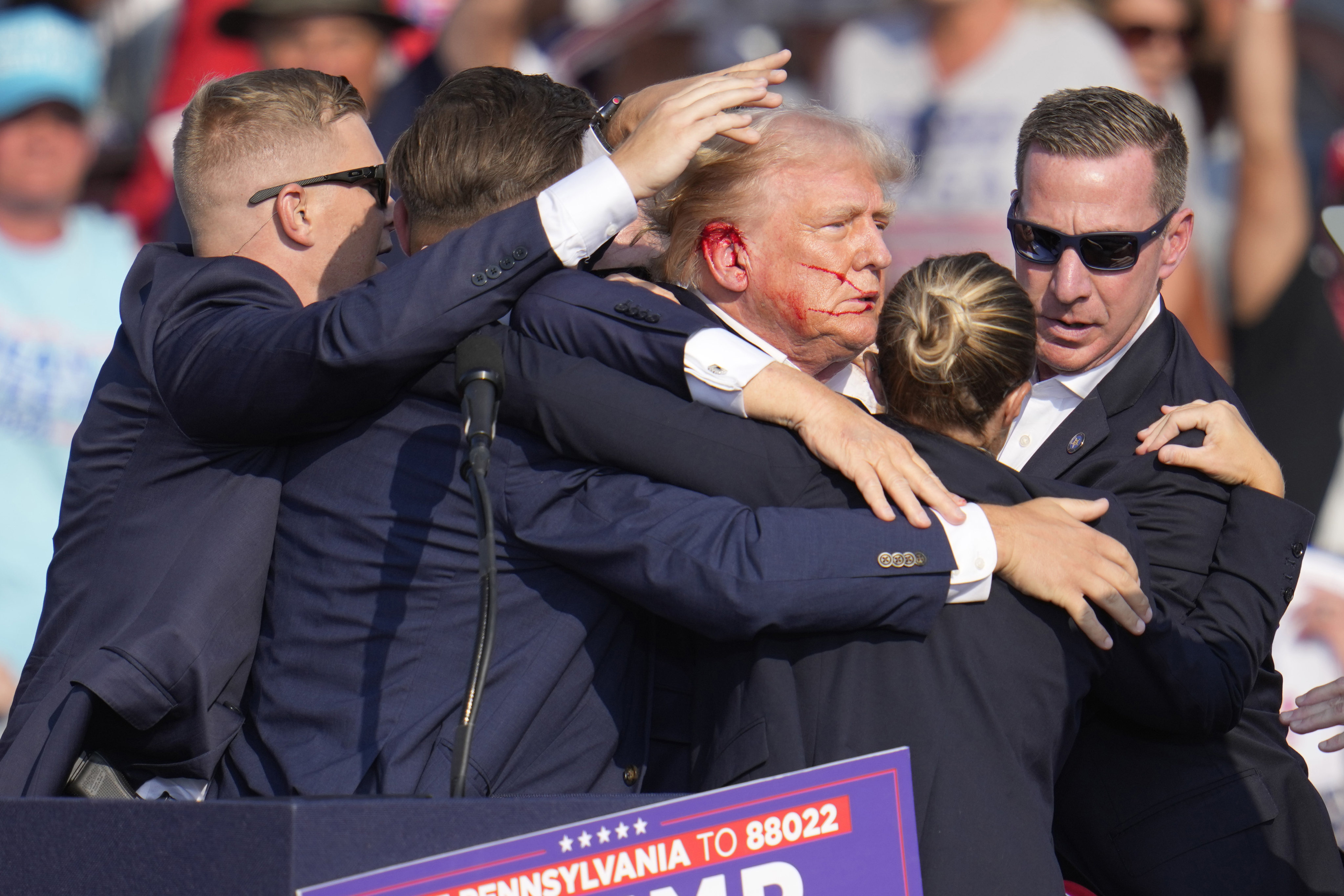 Republican US presidential candidate Donald Trump is surrounded by US Secret Service agents after an attempted assassination at a campaign rally in Butler, Pennsylvania, in July. Photo: AP