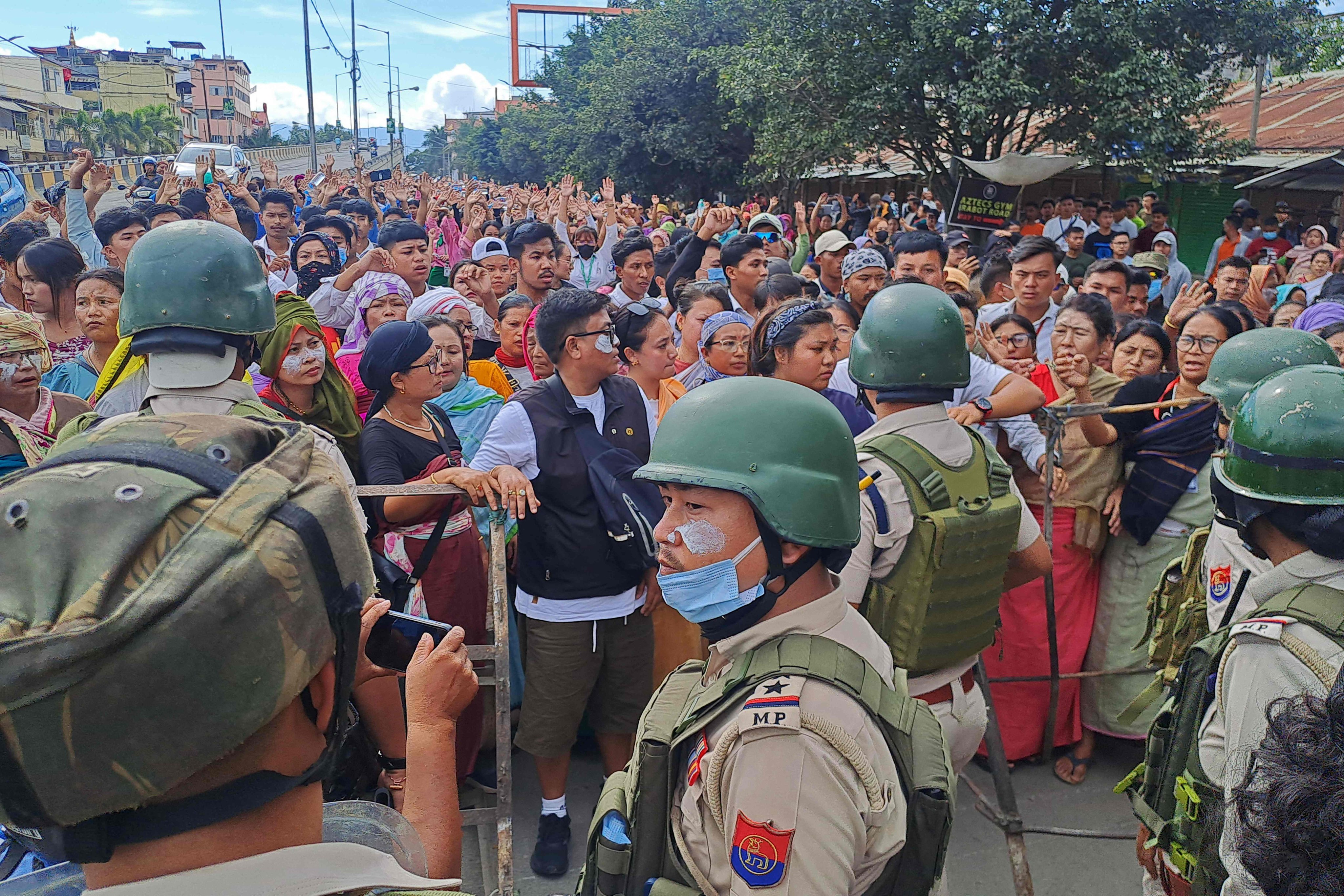 Protesters gather as security personnel block their way along a street during a curfew in Imphal, Manipur, on September 10. Photo: AFP