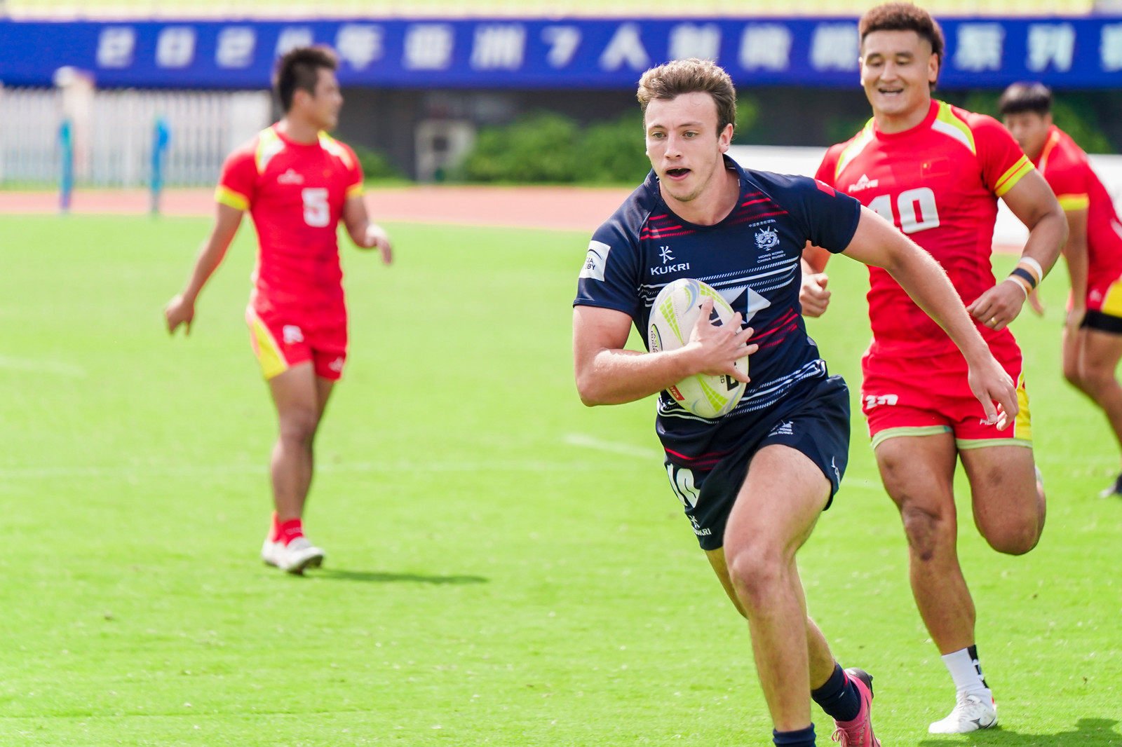 Liam Doherty runs in to score during Hong Kong’s comfortable semi-final victory over China.