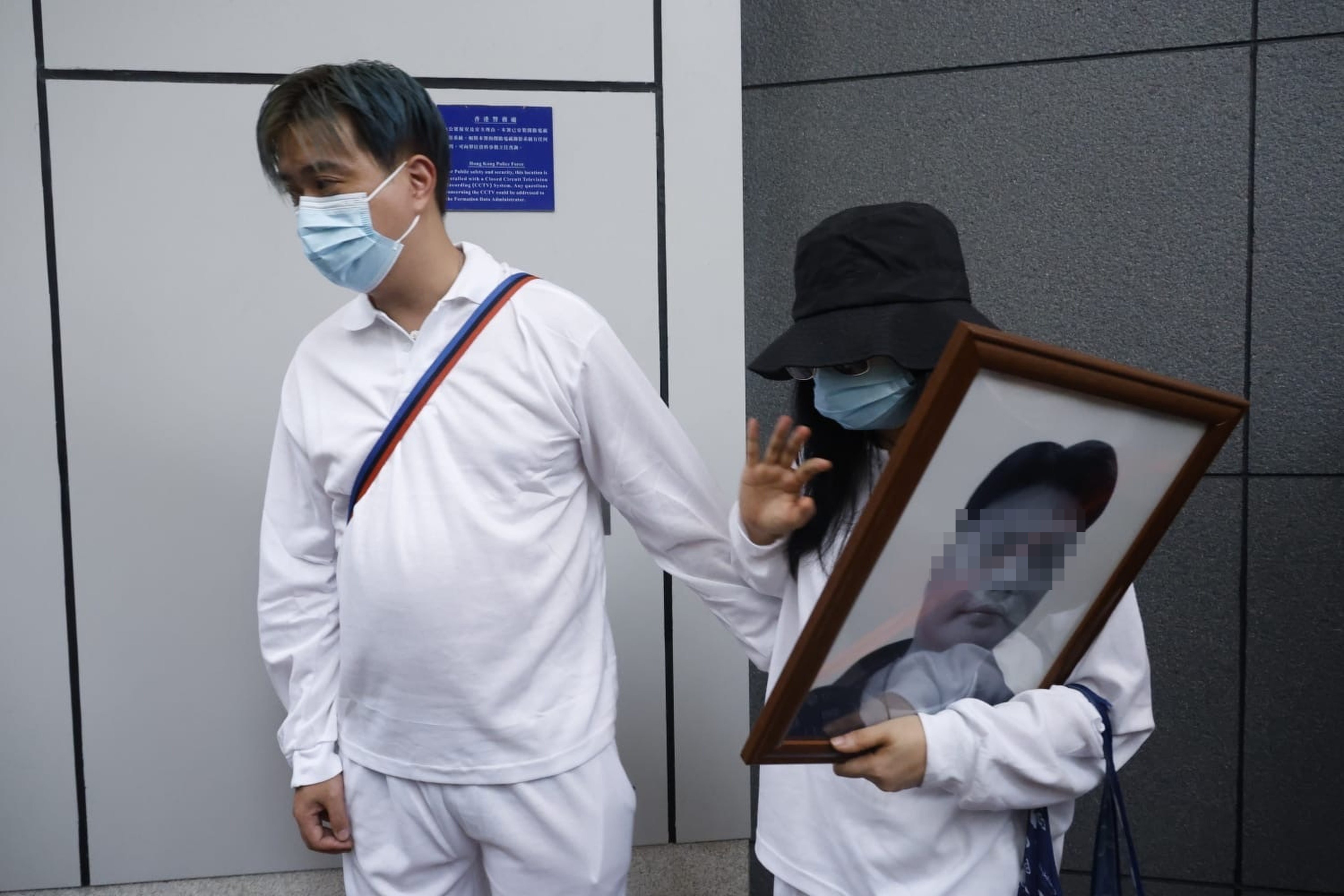 The deceased’s widow (right) spoke to reporters outside police headquarters after filing a formal complaint. Photo: Handout